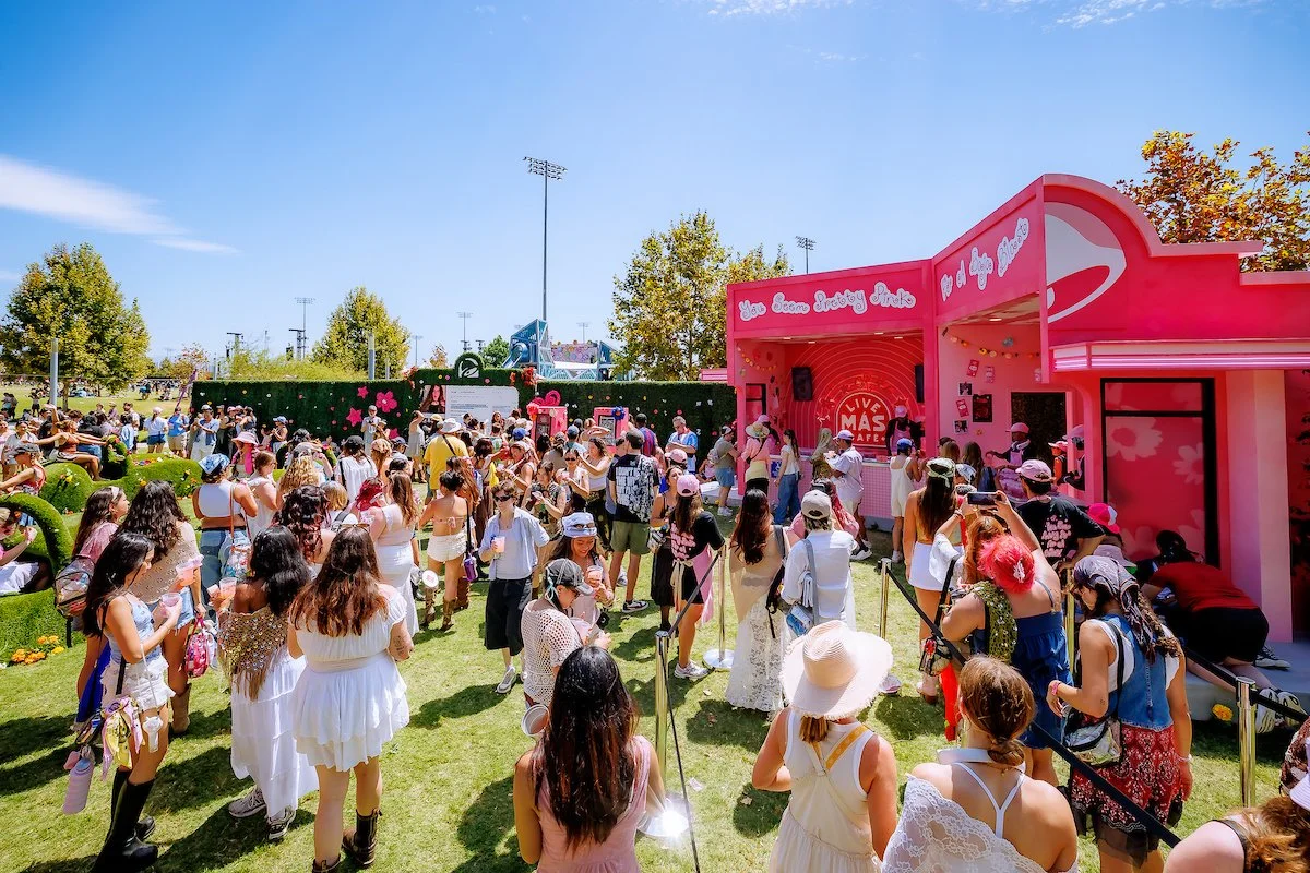 Festivalgoers line up at the pink Taco Bell Live Más Cafe pop-up at Daisy Chain Fields Music Festival