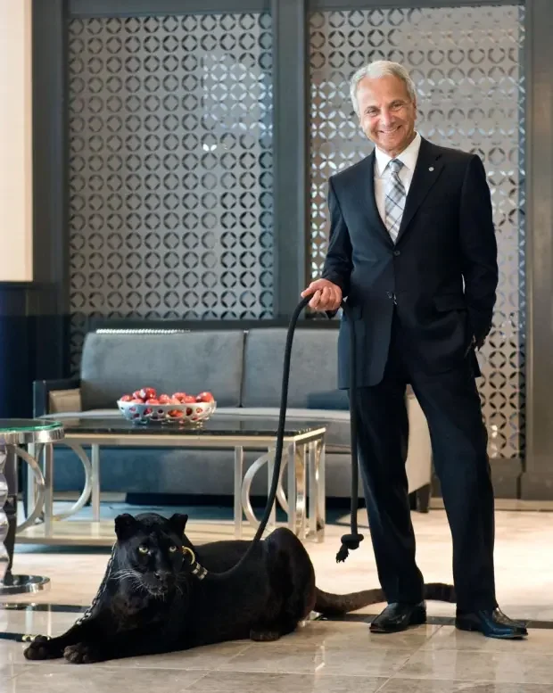 former chapman president james L doti with a panther on a leash