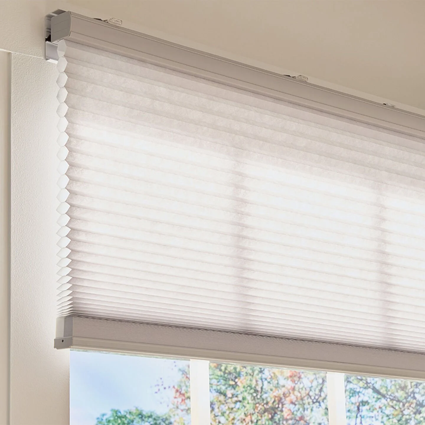 Lutron Triathlon wire-free honeycomb cellular shade close-up showing insulating fabric and ceiling mount bracket