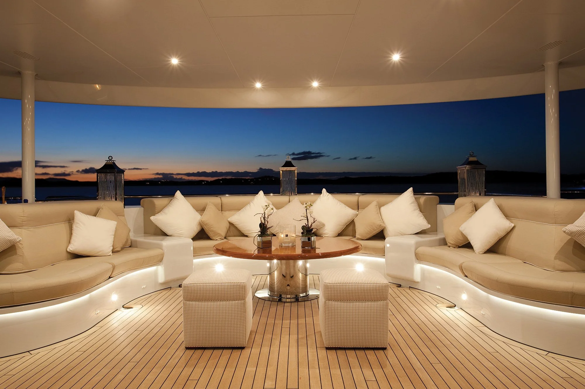 Mega-yacht upper deck lounge with integrated LED accent lighting and recessed downlights at twilight VIP Smart Homes global installation