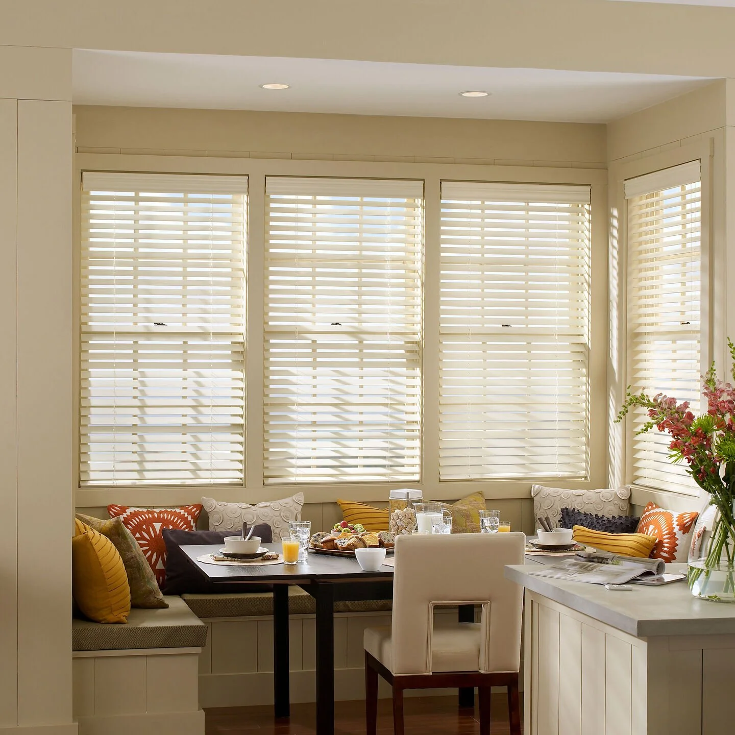 Lutron Sivoia motorized wood blinds in white filtering natural light in breakfast nook VIP Smart Homes dealer