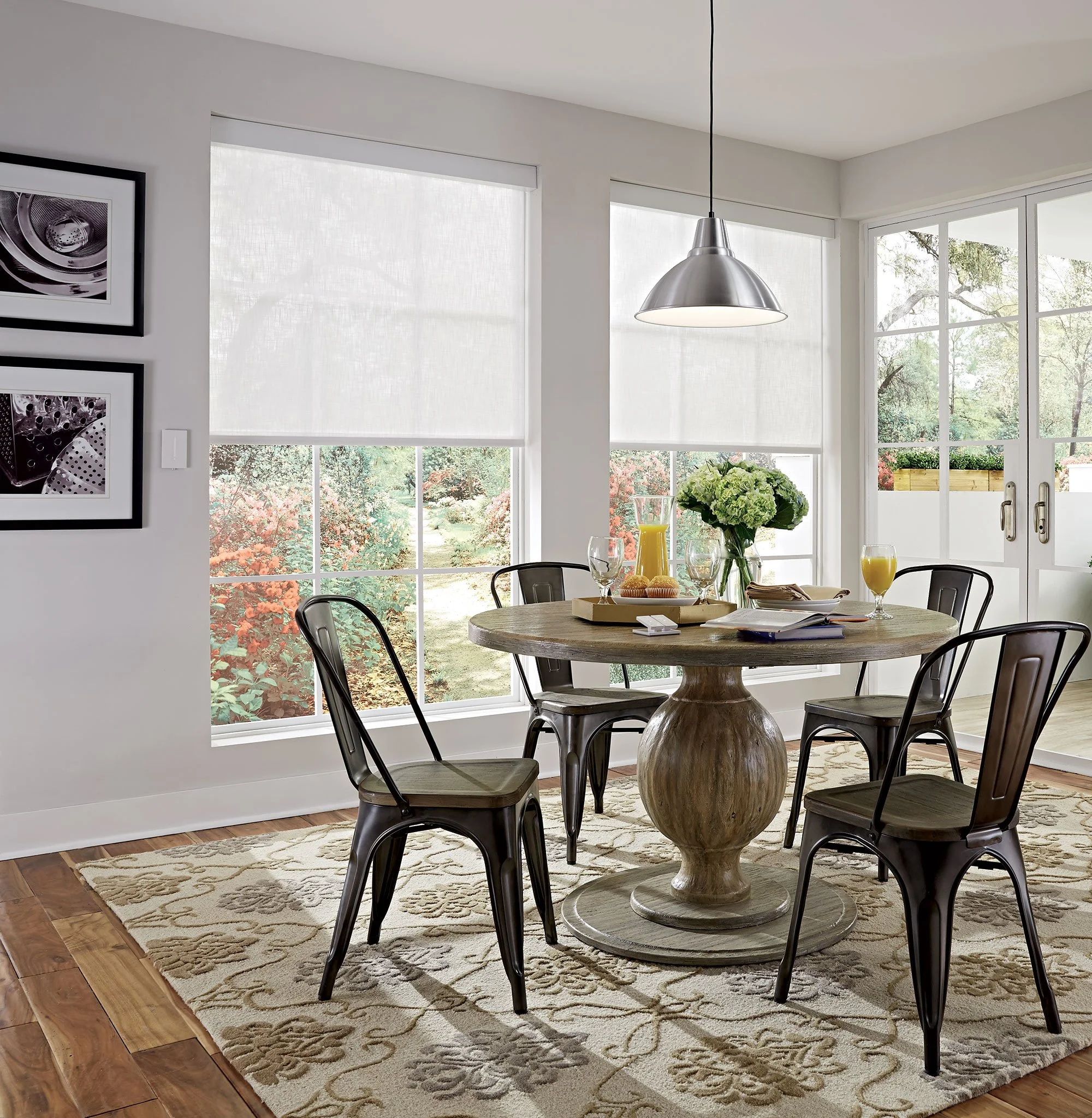 Lutron motorized roller shades in white sheer fabric filtering natural light in bright breakfast room with Pico remote on wall