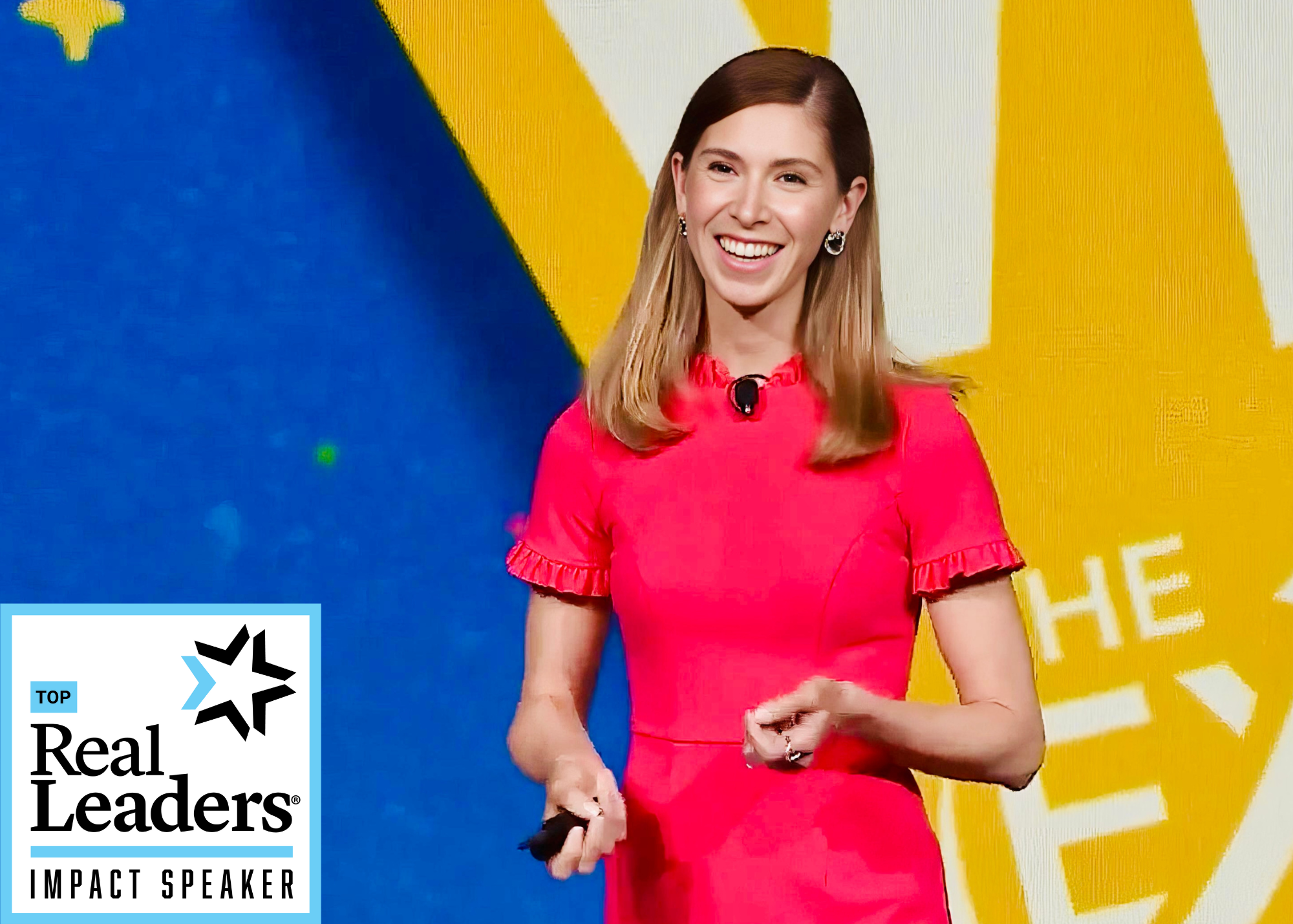 Kristel Bauer, a woman with light brown hair wearing a pink dress, smiling while speaking on stage at a conference with a colorful background. A logo in the bottom left corner reads 'Top Real Leaders Impact Speaker'.