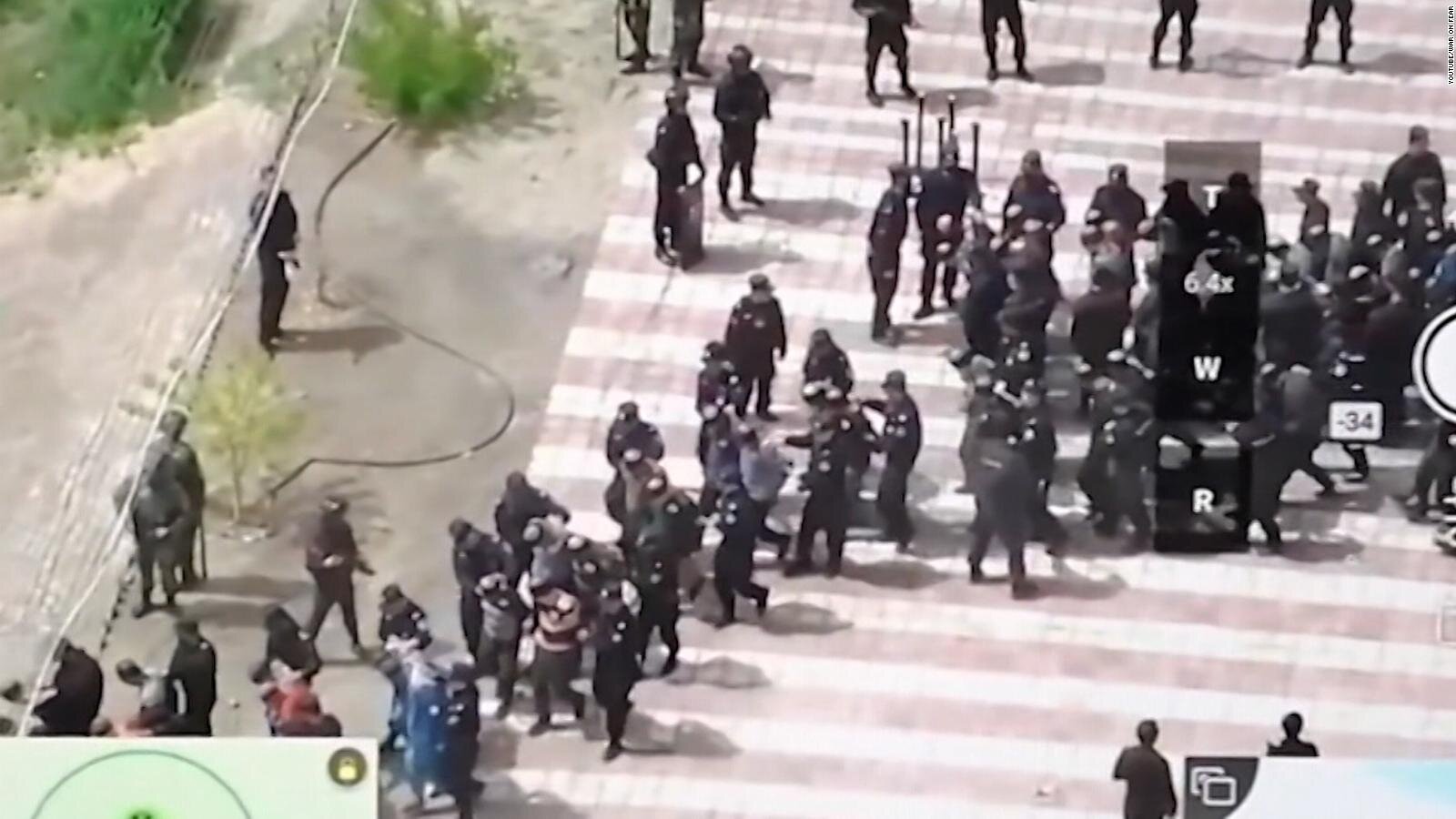Dozens of bond and blindfolded Uyghur Muslim men being taken away by Chinese police.