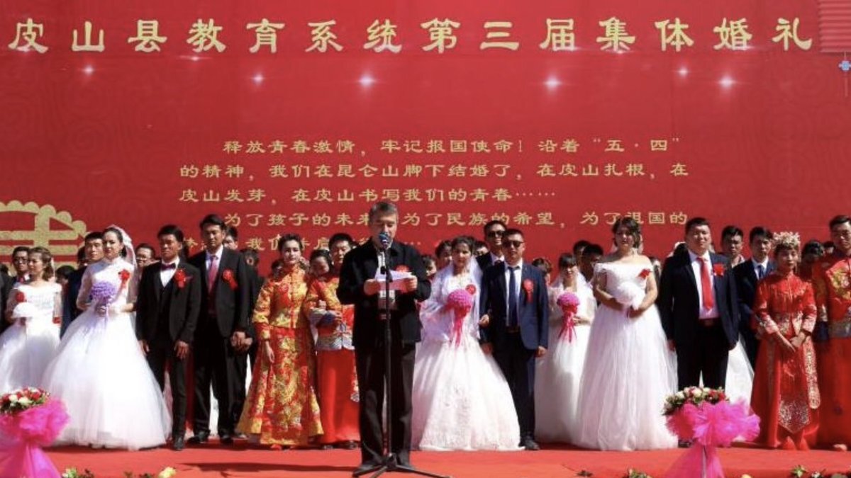Uyghur women being forcefully married to Han Chinese men at a CCP propaganda event.