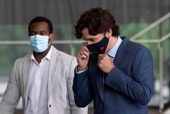 Prime Minister Justin Trudeau fiddling with his mask.