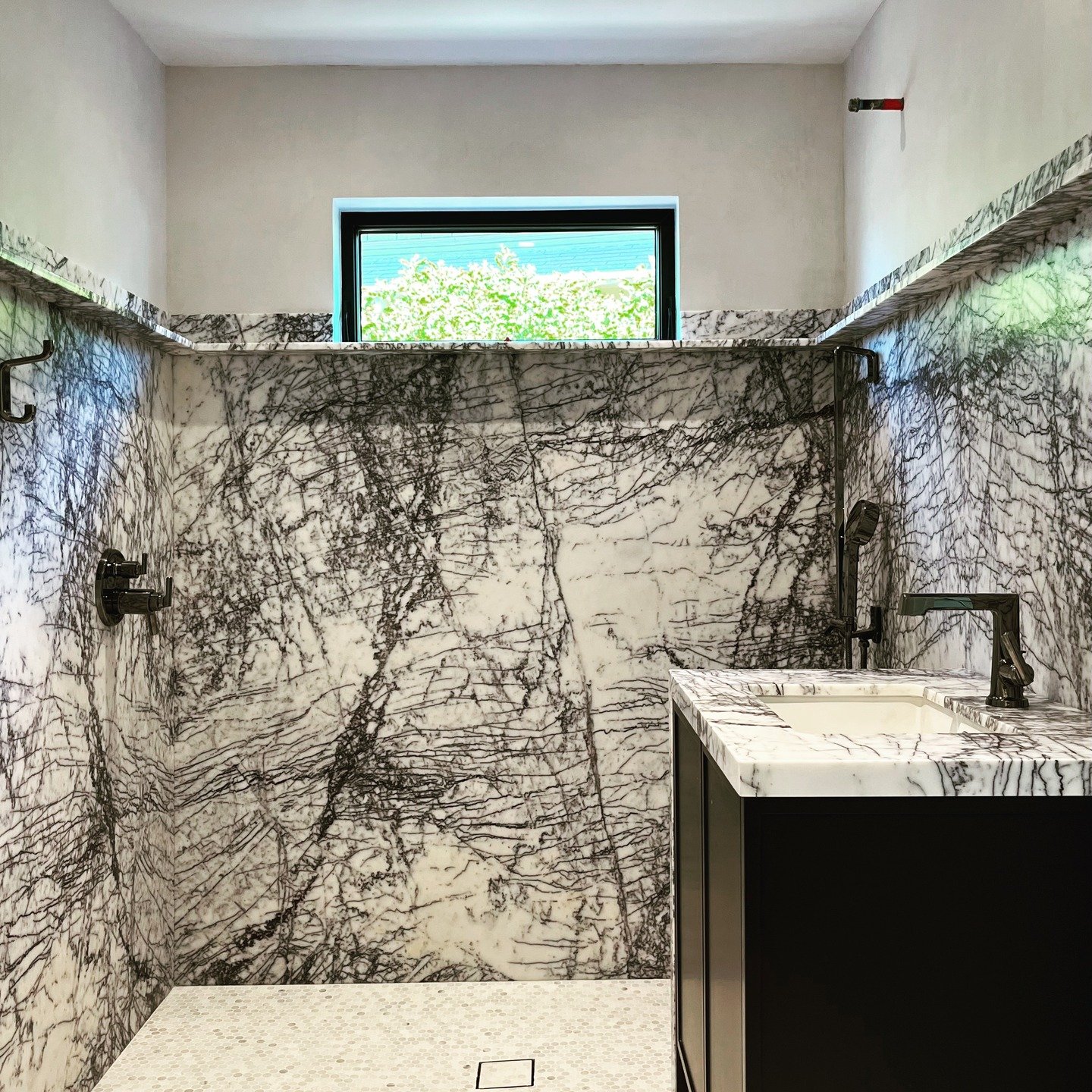 Sometimes when you get something just right, it disappears. Finding the exact off white/soft gray lime plaster to harmonize with this gorgeous marble and tile was a challenge but, once we got it, the room just came together.