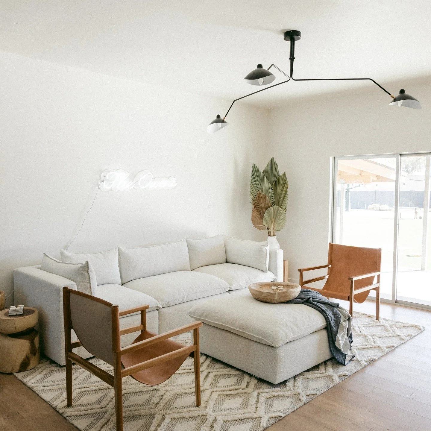 A harmonious blend of simplicity and elegance. 

I absolutely love how there's a combination of minimalism, understated elegance, and sophisticated furniture that perfectly complements the neutral tones of the design. Really creates a calming and inv