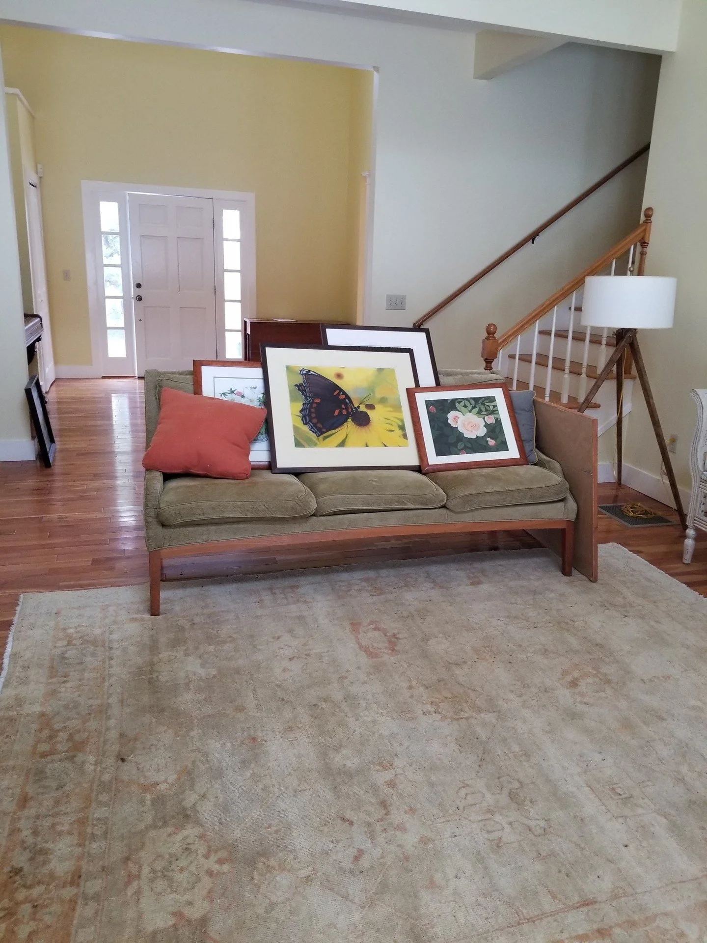 Yellow walls. Frames leaning on the sofa. No point of view. Not anymore.

The entry and living room of this home had everything going for it; soaring ceilings, beautiful hardwood floors, a fireplace, and nothing pulling it together.

We painted every