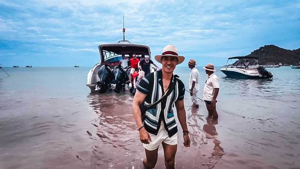 Rom wading through the sea after arriving at the Anantara Koh Phangan by speedboat