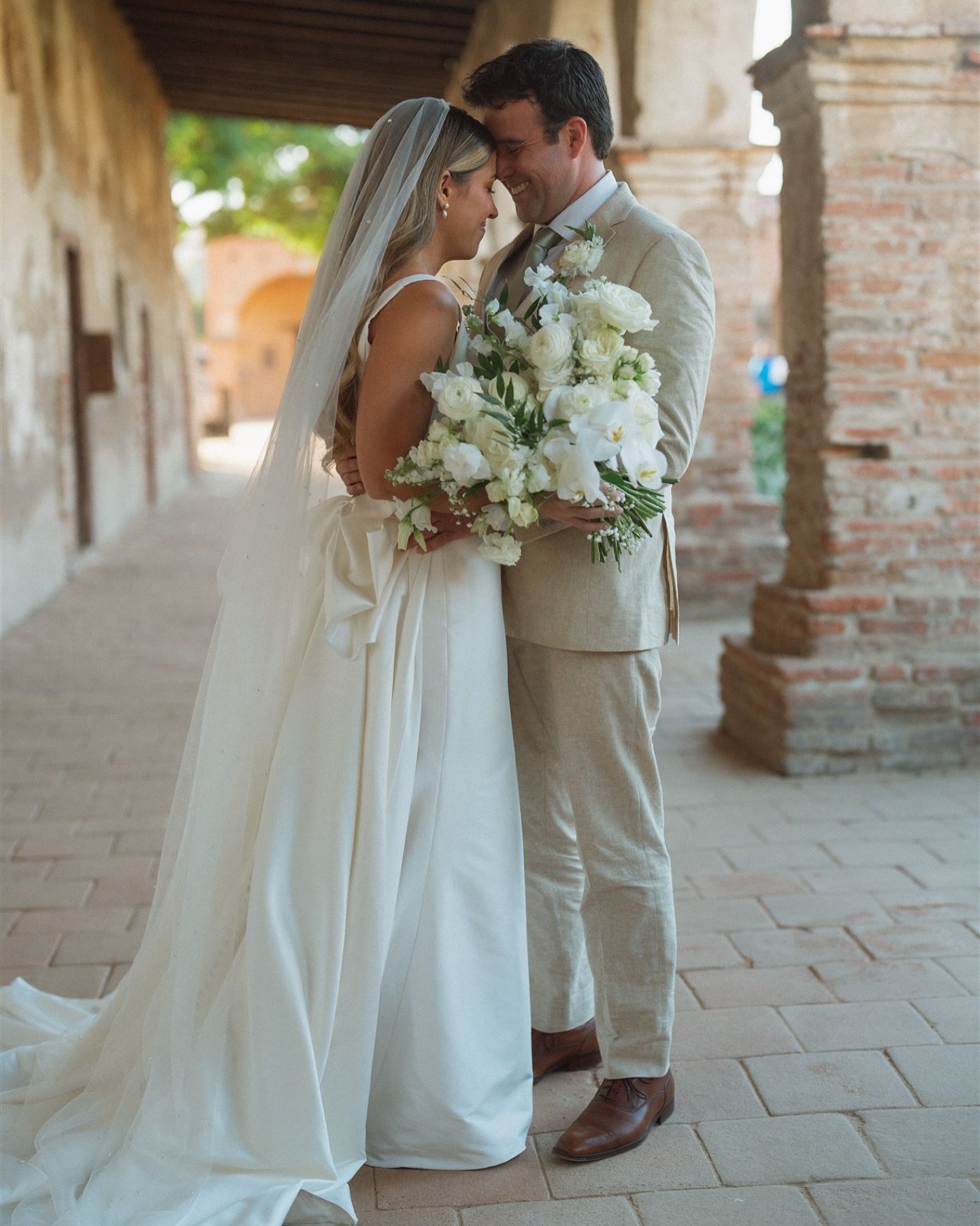 Weekend wedding dreams look a lot like this.
Elegant blooms, timeless love, and the kind of moments that make your heart skip a beat.

Tucked beneath the arches of history, these two shared a quiet moment before the celebration began&mdash;surrounded