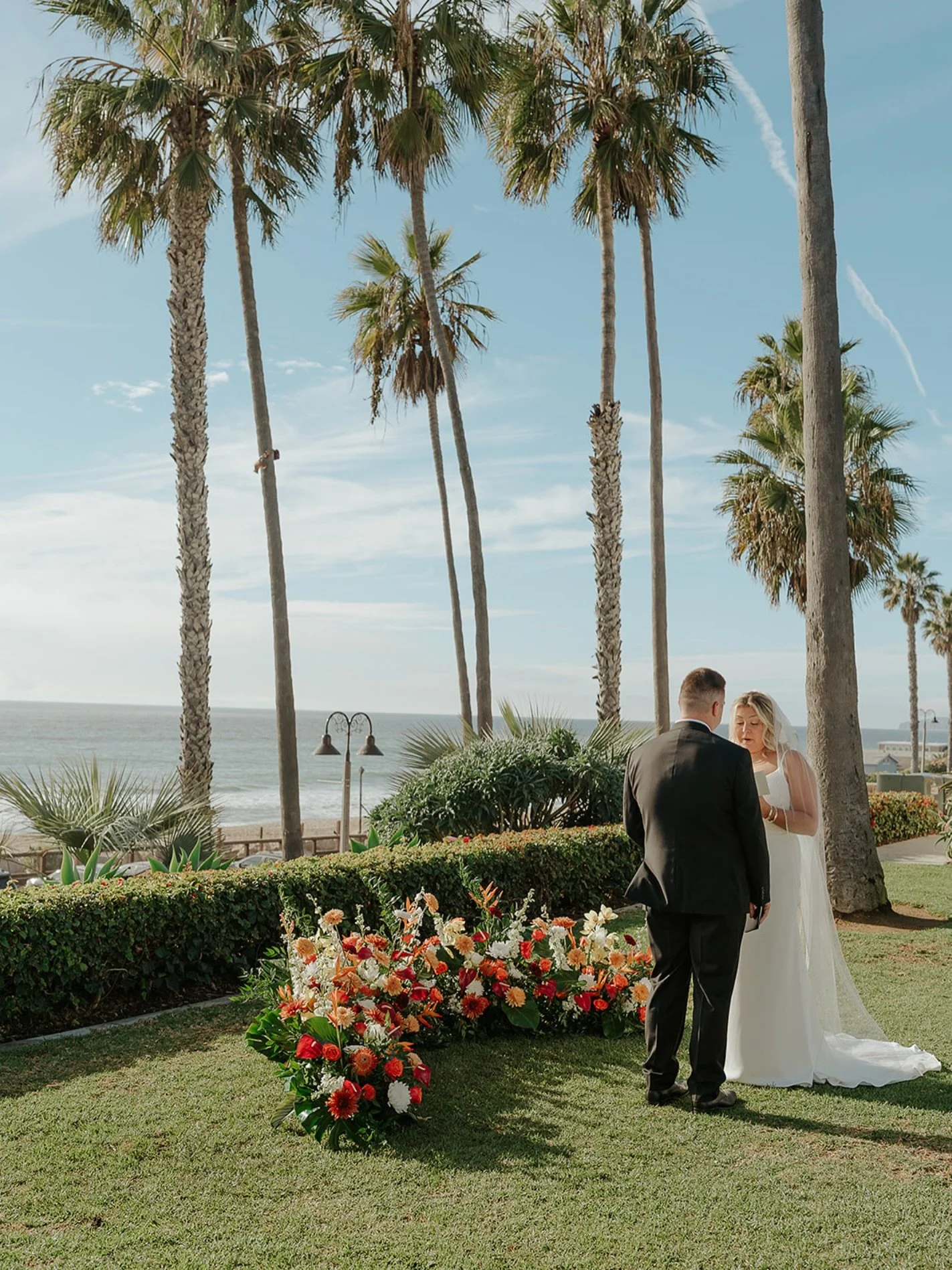 Ocean views, vibrant florals, and vows under the palms 🌴🌺

Carlyn &amp; Austin&lsquo;s seaside ceremony was nothing short of magical. We designed this lush ground floral installation in bold, cheerful tones to pop against the natural coastline back