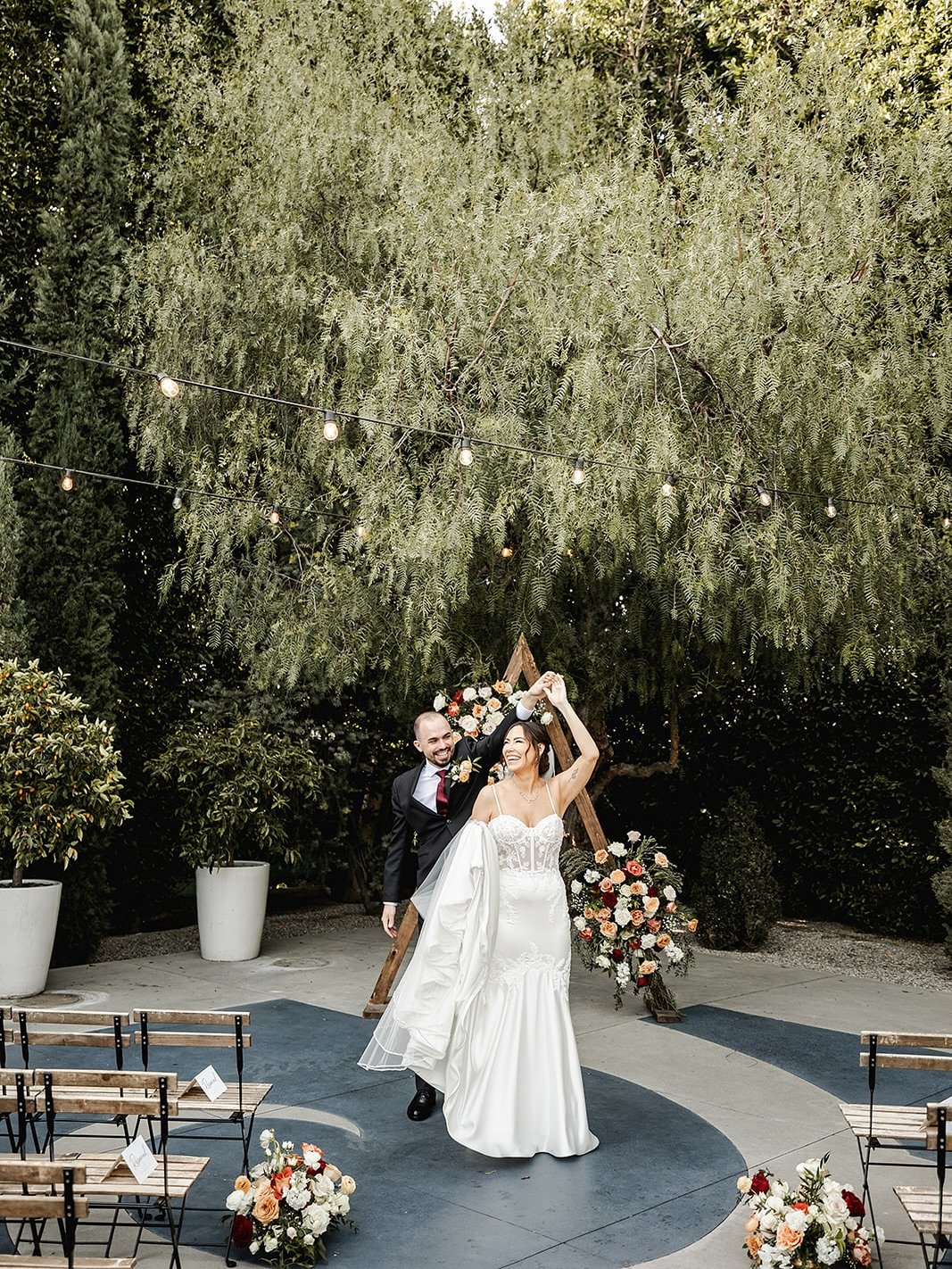 A dreamy Fig House courtyard moment ✨ Our triangle arch dressed in lush blooms was the perfect frame for &lsquo;I do.&rsquo; Still swooning over this setup.

Planning+Florals : @ruffleeffect
Venue : @thefighouse
Photo/Video : @mcj_impressions
DJ : @s