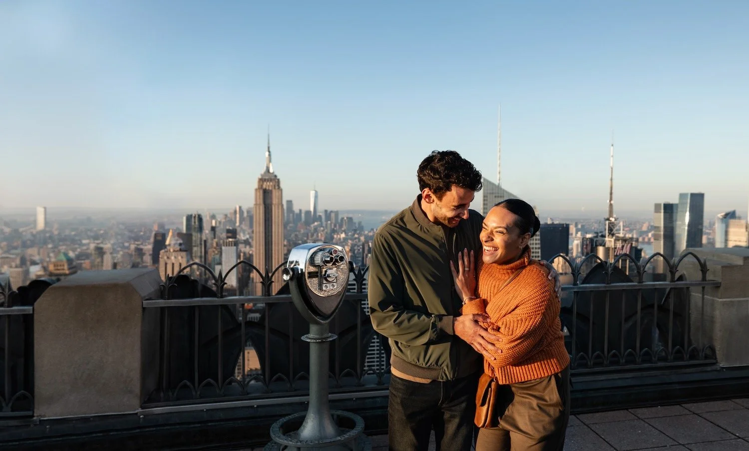 Two people enjoying the view at Top of the Rock in New York.