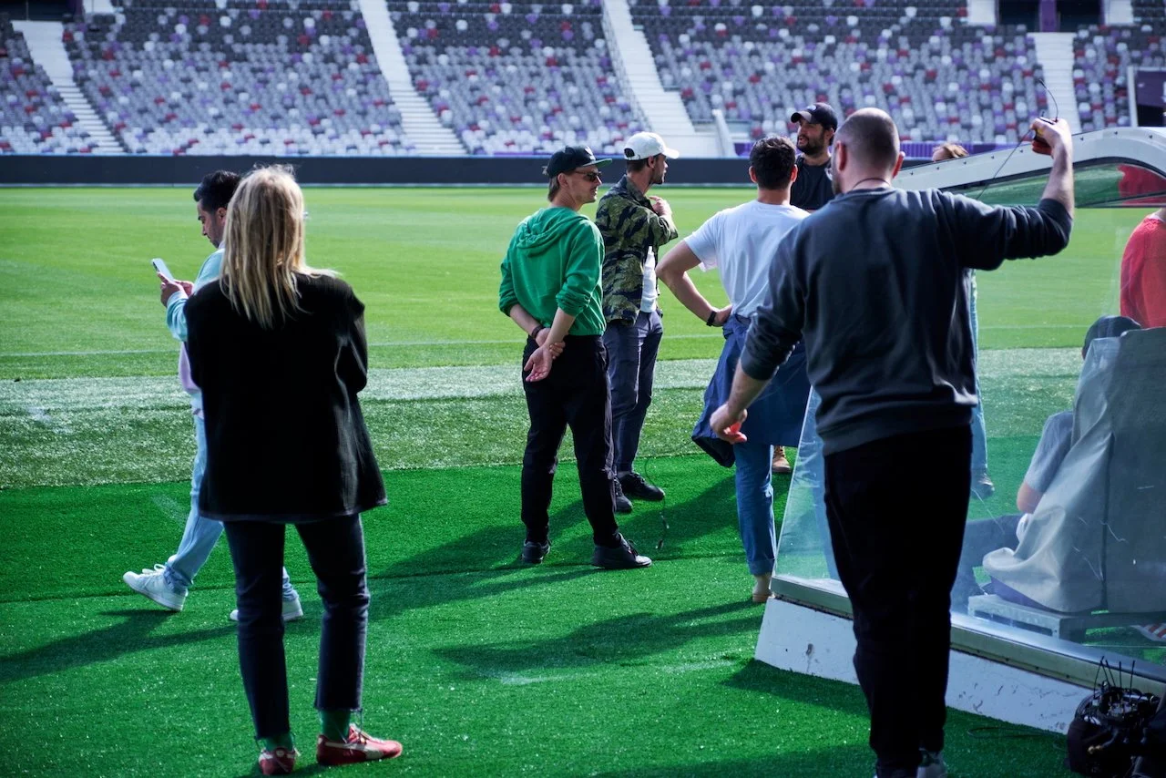 In the stadium preparing for the scene.