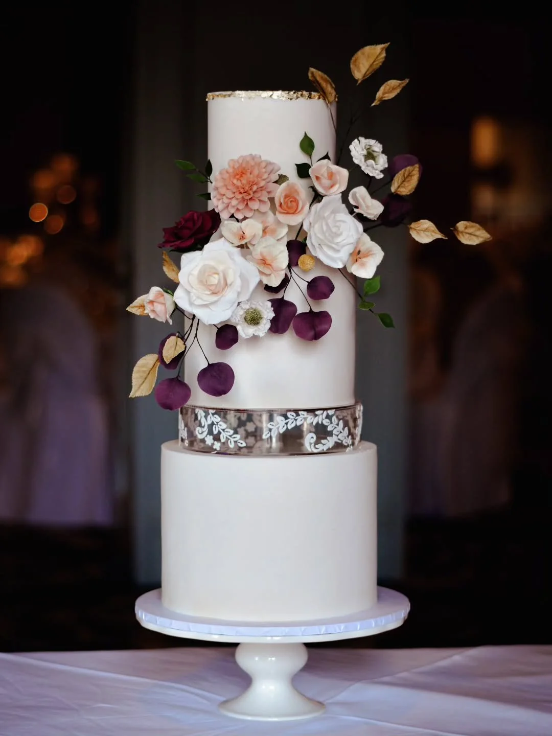 The beauty of sugar flowers is that they can be created in any colour you like. Here, we introduced deep purple and ochre tones to give an elegant autumnal feel without always opting for vibrant oranges.