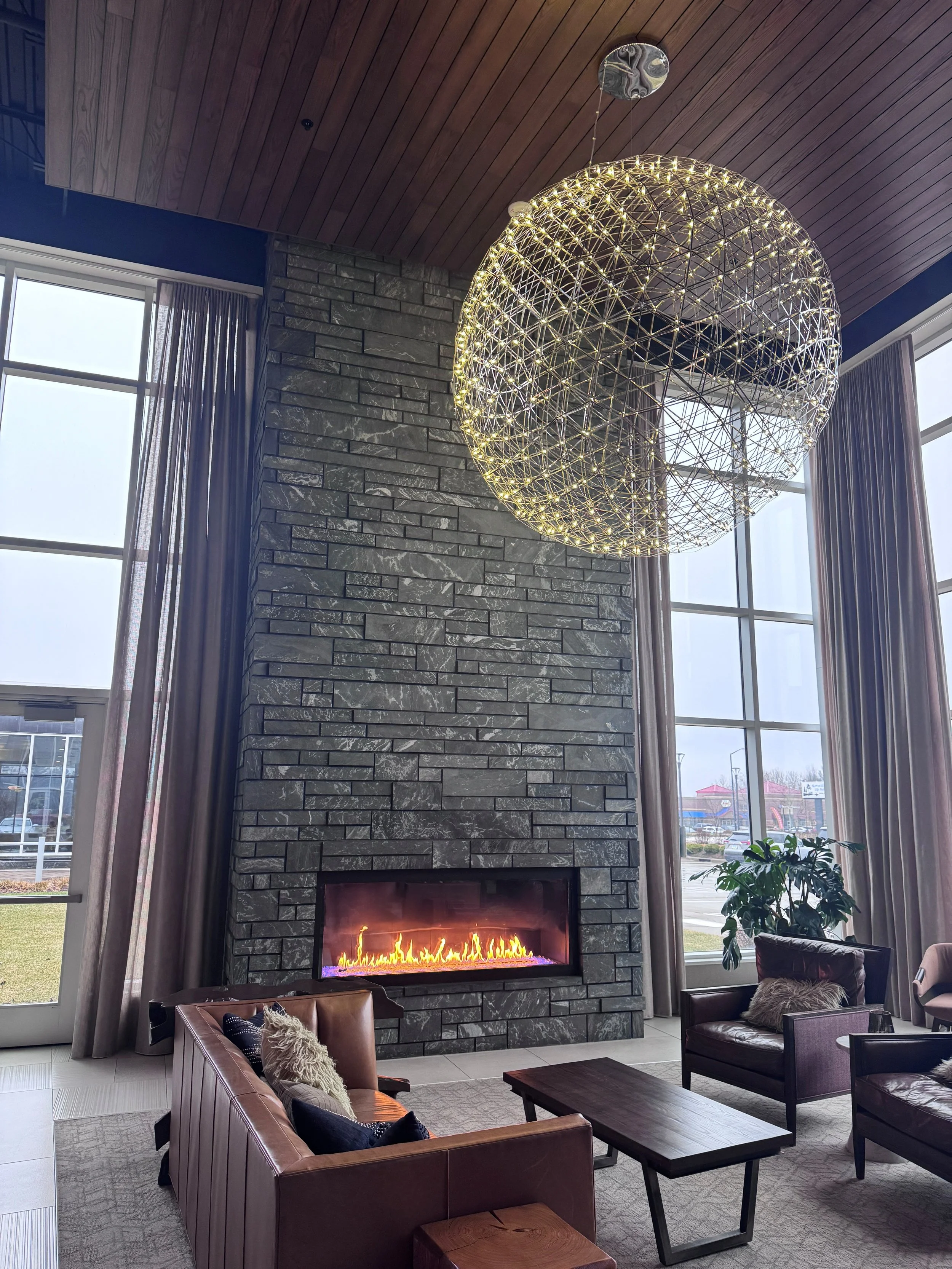 Aqua Grantique sawn height 3 1/2" & 7 1/2" full veneer.  The stone was intentionally set with varying projections to create depth, texture, and visual interest across the façade.