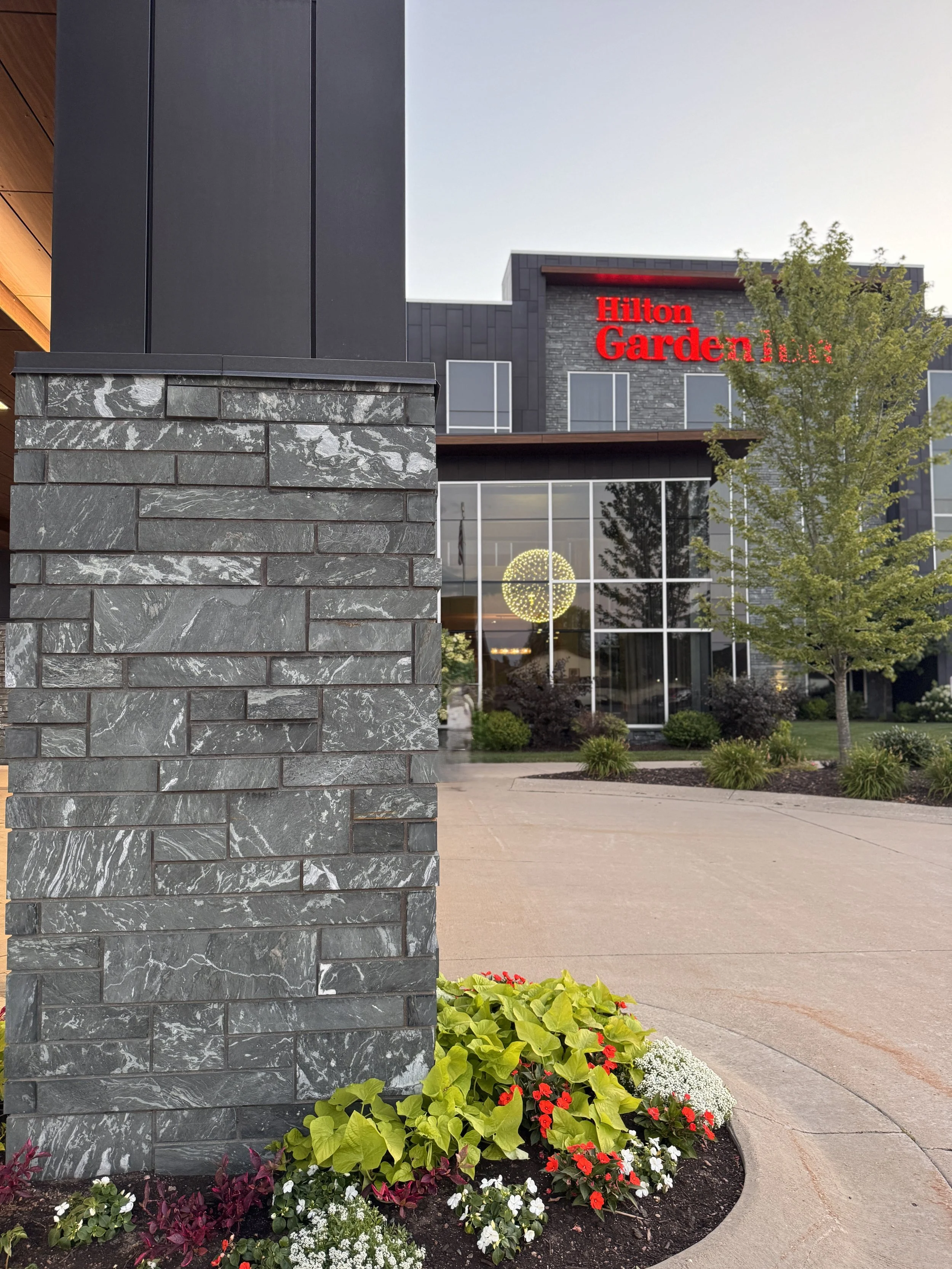 Aqua Grantique sawn height 3 1/2" & 7 1/2" full veneer.  The stone was intentionally set with varying projections to create depth, texture, and visual interest across the façade.