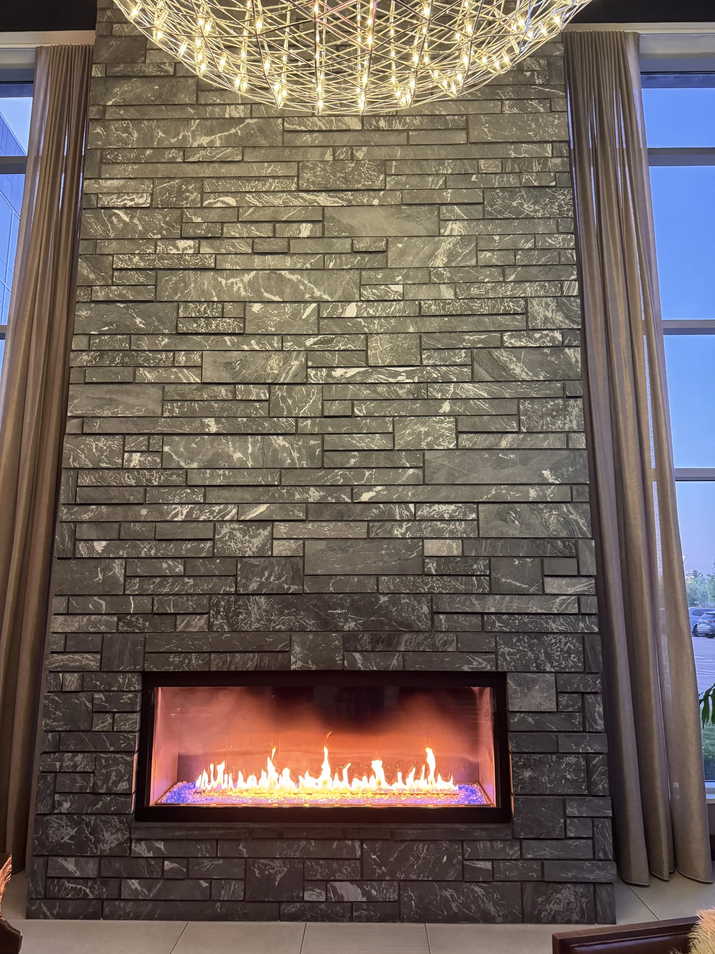 Aqua Grantique sawn height 3 1/2" & 7 1/2" full veneer.  The stone was intentionally set with varying projections to create depth, texture, and visual interest across the façade.