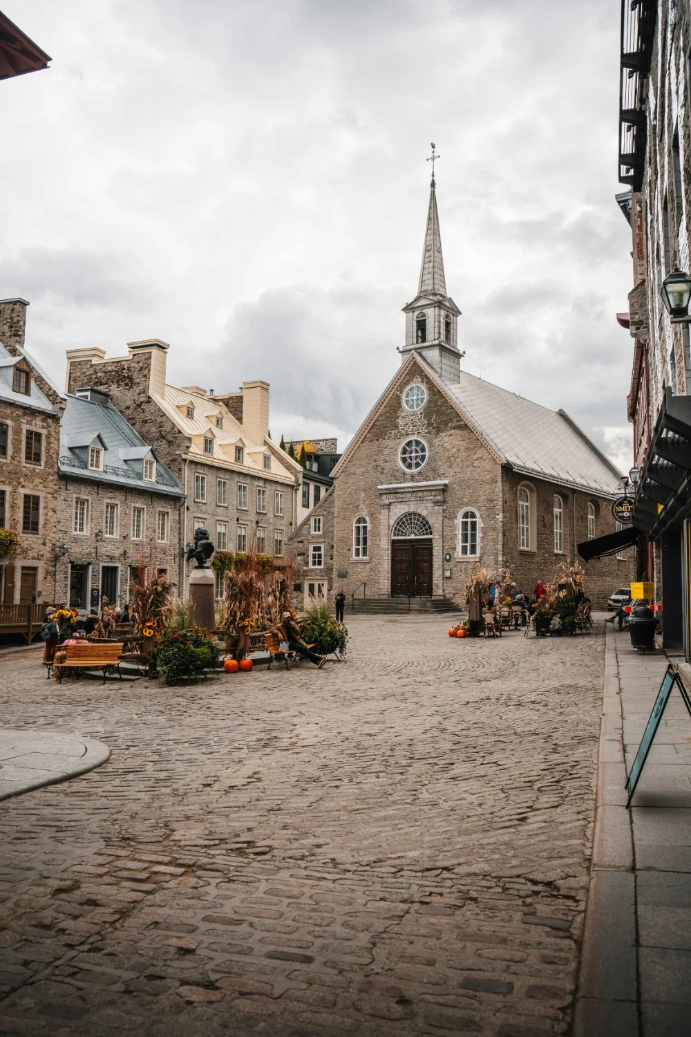 Historic stone church in Old Quebec surrounded by cobblestone streets and buildings, illustrating the setting of many Quebec baptism records.