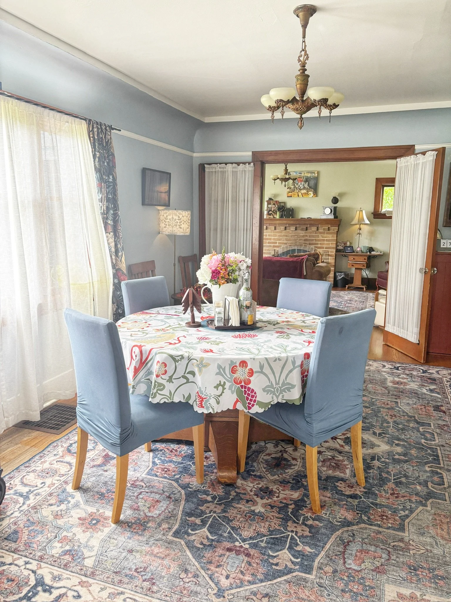 Inviting dining room with classic furnishings, abundant natural light, and an open flow to the cozy living room.