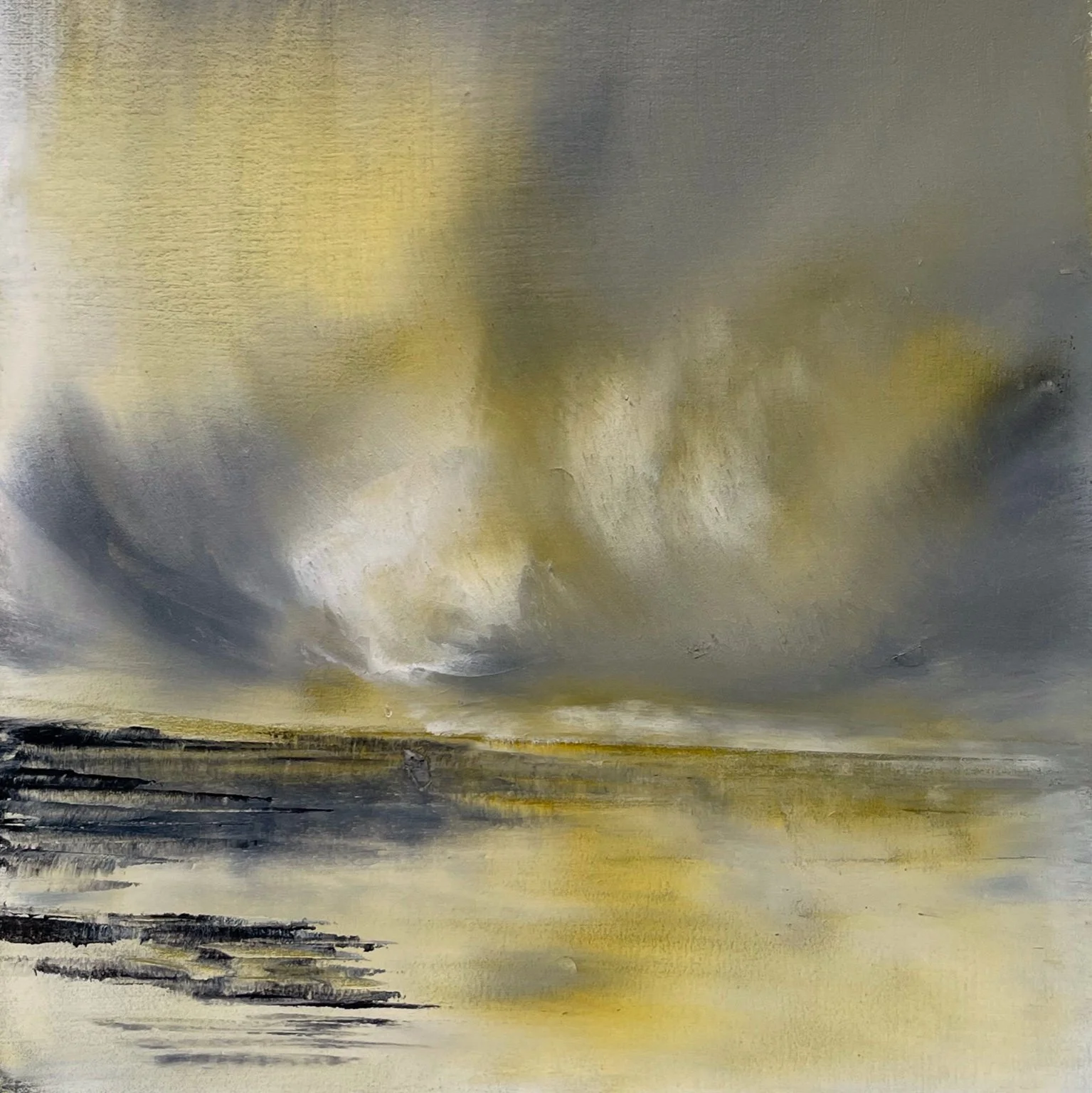 A dramatic sky pushing weather across the landscape, heavy clouds gathering over muted earth tones.