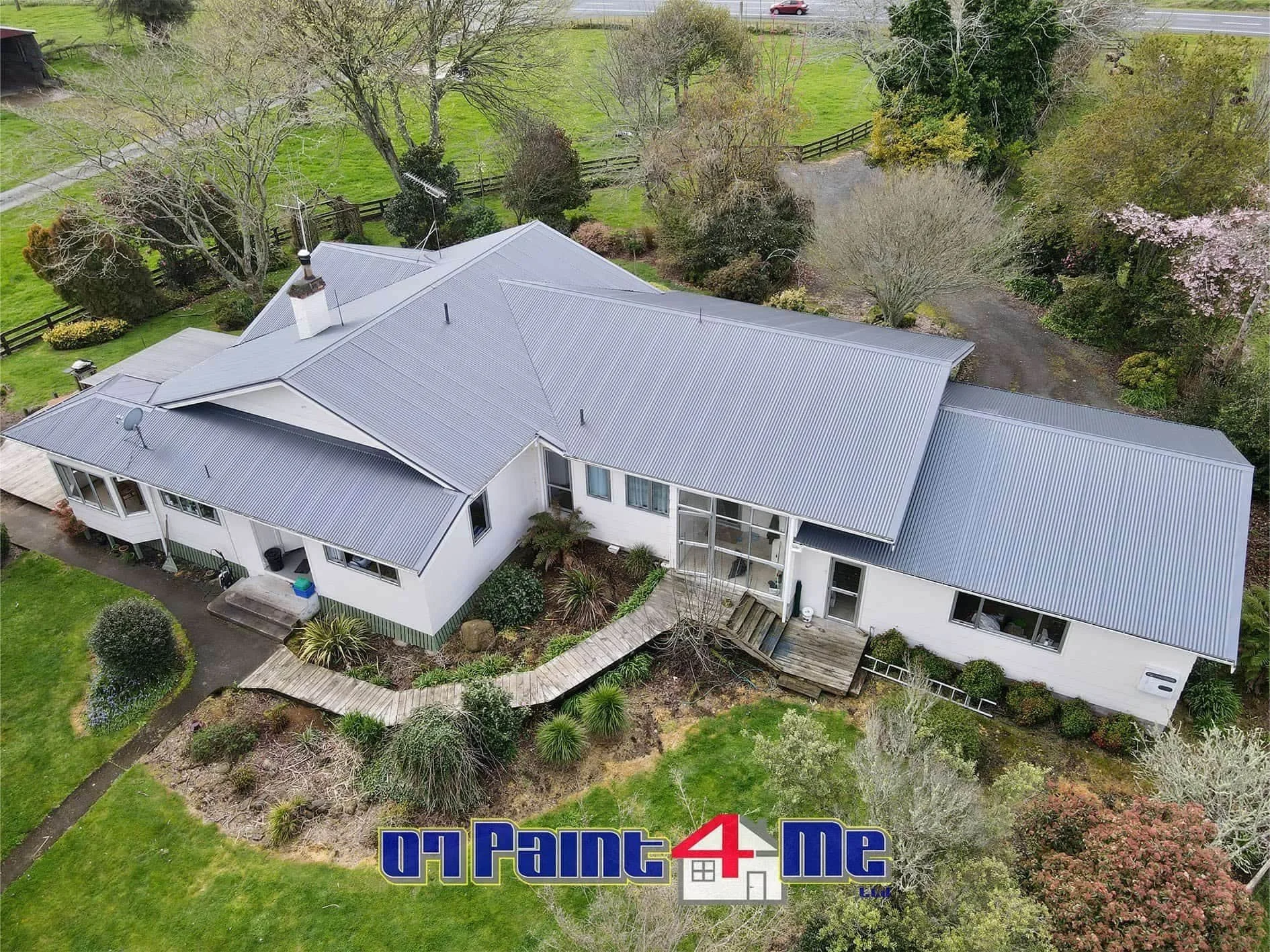Aerial view of a farmhouse with a freshly painted grey metal roof. There is a "07Paint4Me Ltd" logo at the bottom of the image.