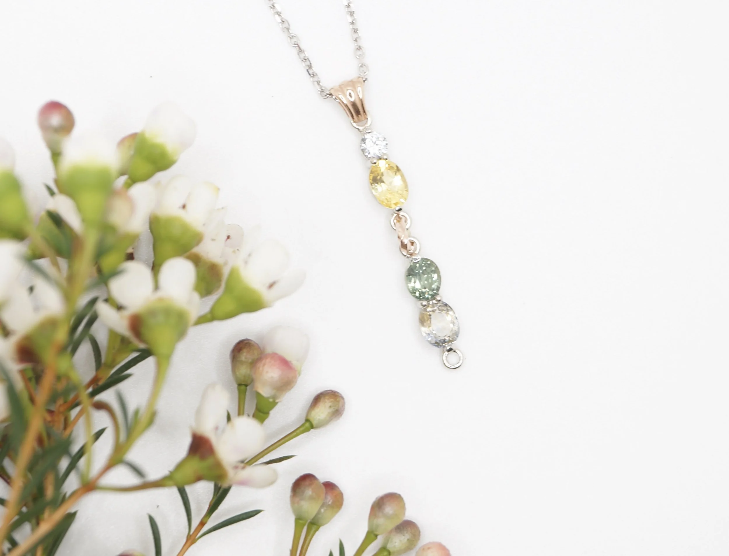 A multi- colored gemstone pendant custom designed using the customers stones to create a whimsical style.