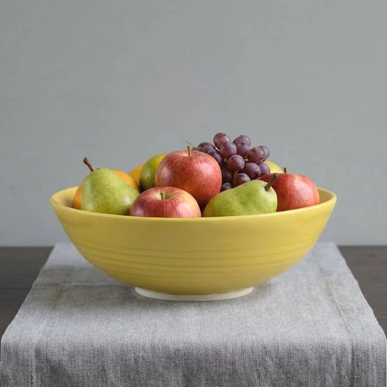incised porcelain bowl with ochre glaze