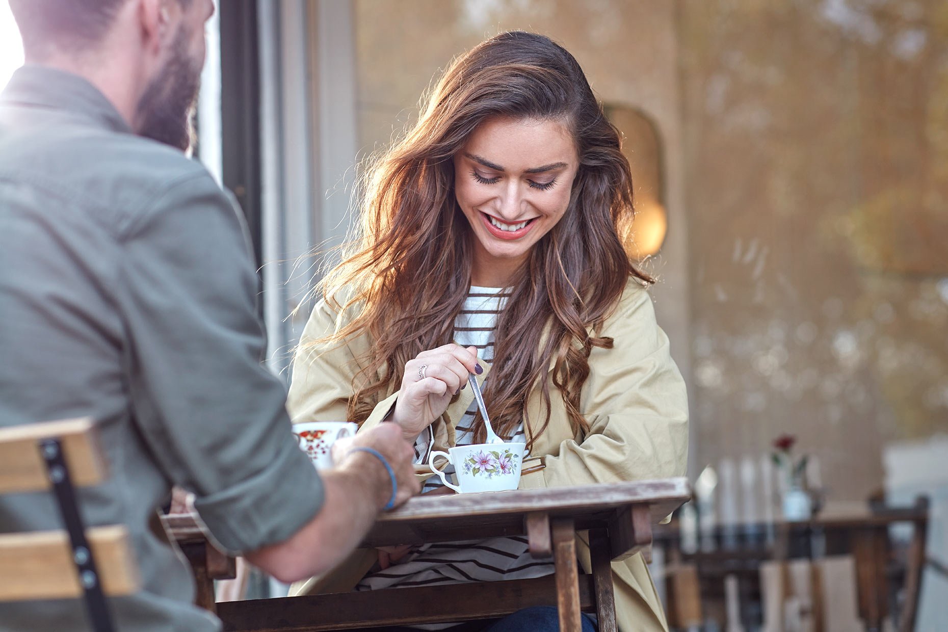 smiling-couple-drinking-tea-in-cafe.jpg