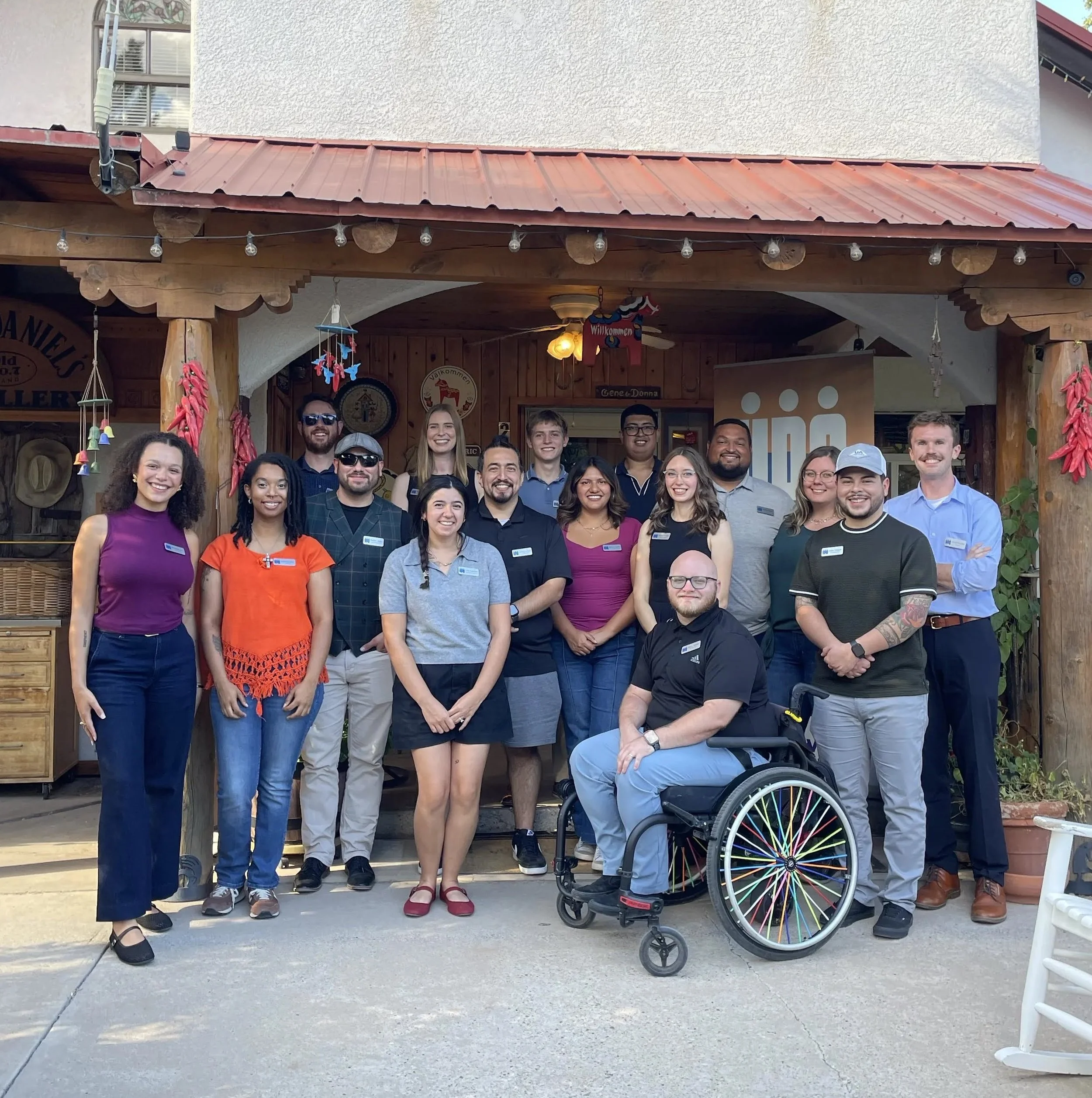 Board of Directors group standing for picture in front of home.
