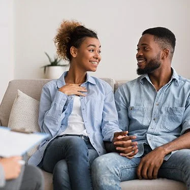 Couple sitting on couch talking