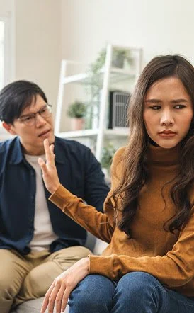 Couple arguing while sitting on the couch