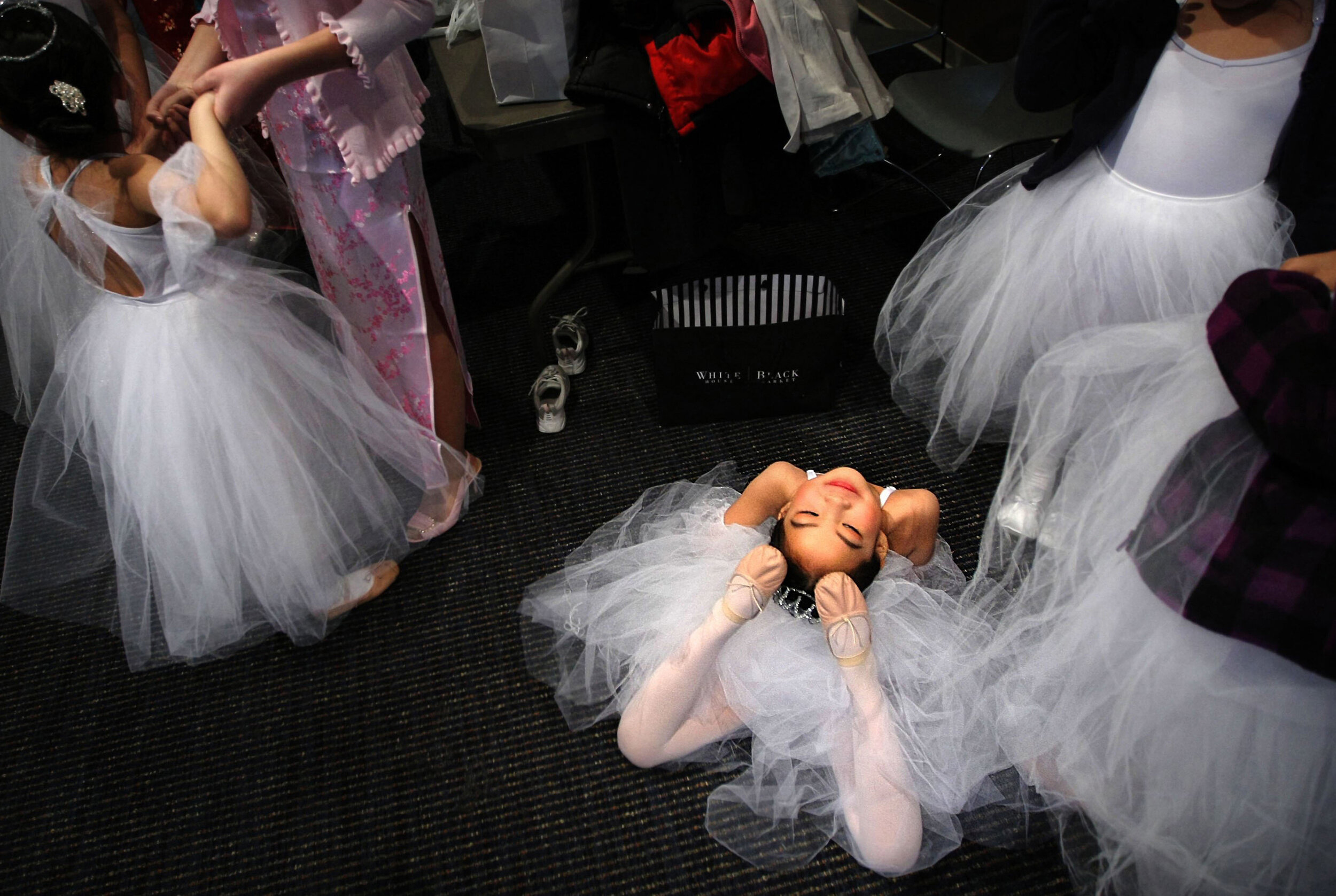   Grace Jiang, 7, stretches out as fellow ballet dancers from the Memphis Chinese Language School prepare to perform the Waltz of the Snowflakes Sunday afternoon before the start of the Chinese New Year Festival at the Rose Theater. 