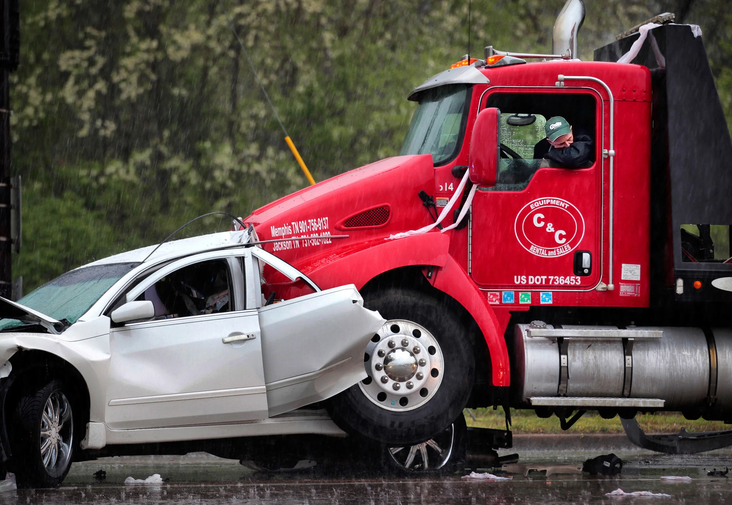  Mark Moore with C&amp;C Equipment waits in his truck for a tow after a multi-car pileup on Riverdale Road at Holmes sent several people to the hospital, including one person in critical condition who had to be extricated by firefighters from a vehic