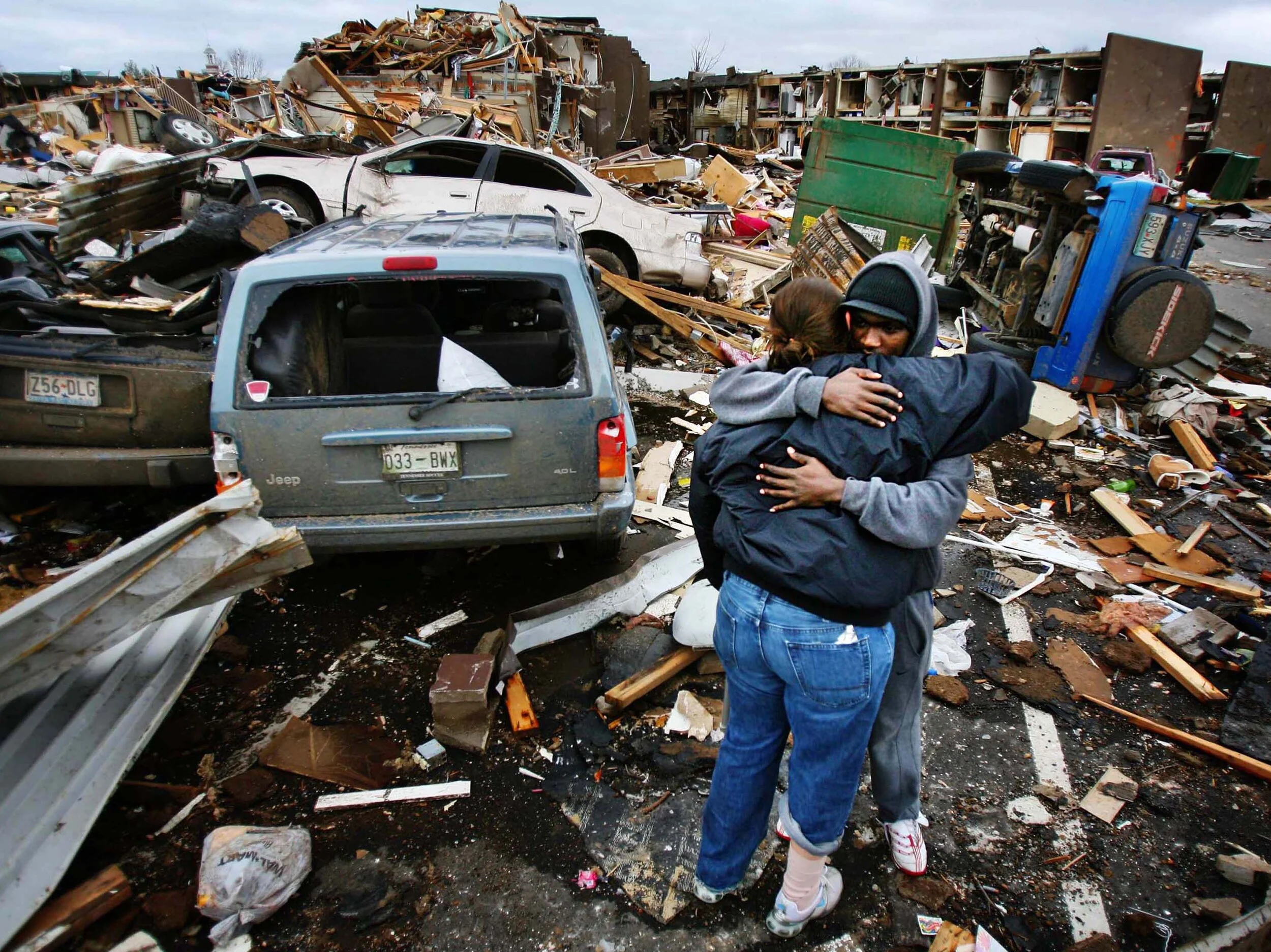  Union University's Lindsay Parrish of Memphis gets a hug from fellow student  Eric Uwiringigimana of Rawanda as they look for the wreckage of her car at Union University in Jackson, Tenn., where a tornado ripped through dorms and overturned cars Tue