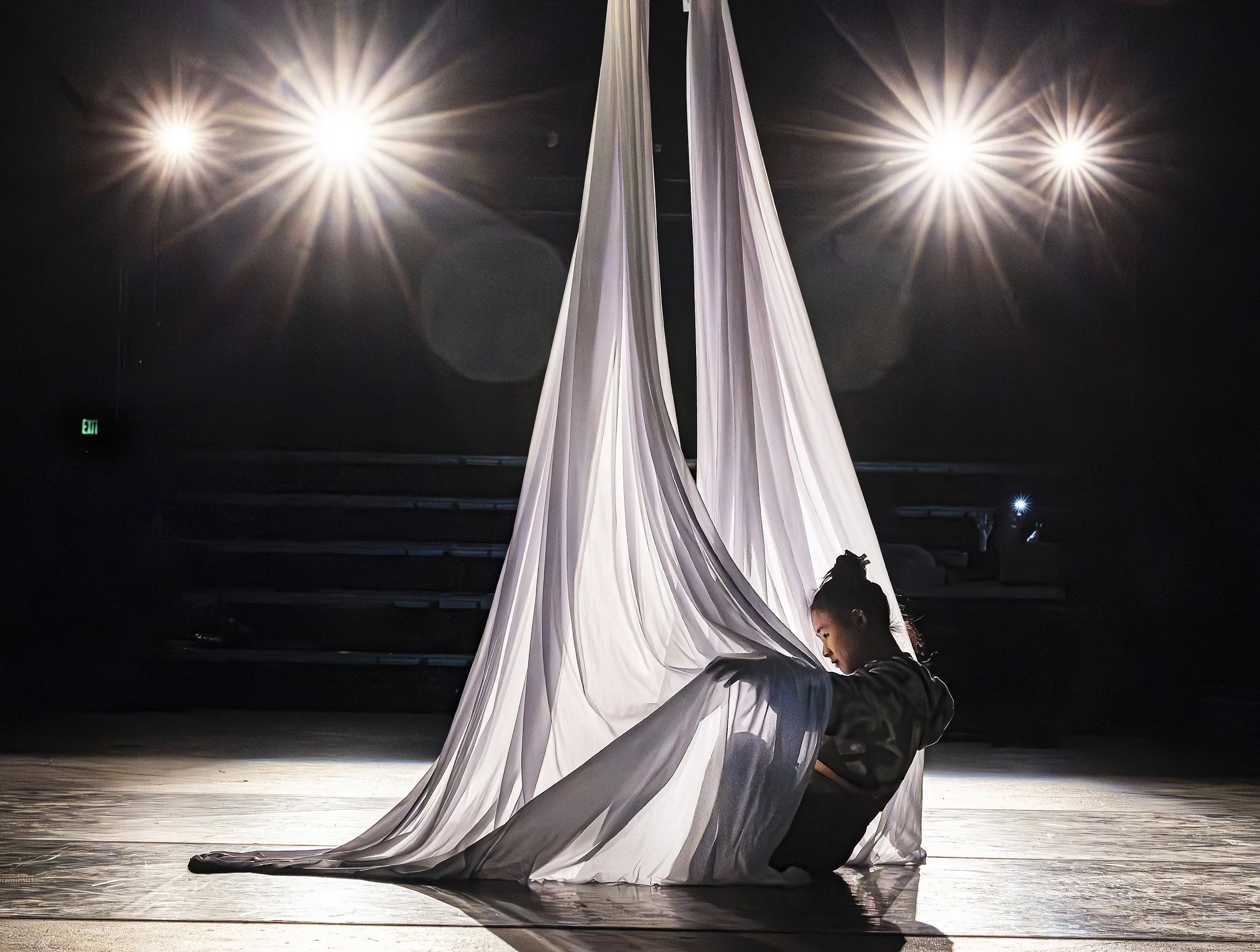  Mei Wang begins her aerial silks performance as members of the Wise Fool cast rehearse on Tuesday, April 14, 2026, for their first show in the troop's new midtown home at Aspect Studios. Their show, "Entrapping Our Abundance" is a family-friendly ci