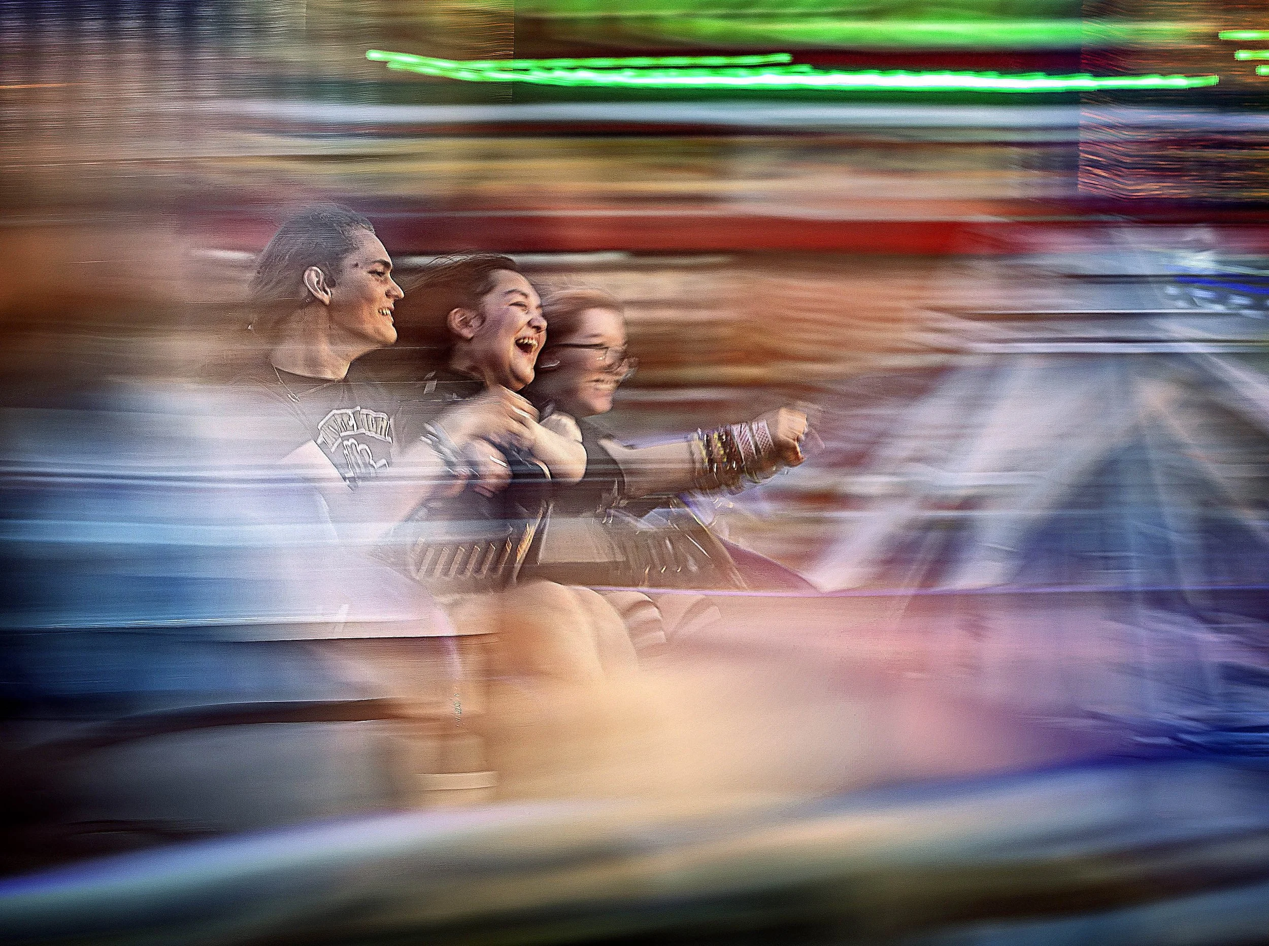 Leo Rodriguez, Nevaeh Chavez and Isabella Anderson take a spin in "The Sizzler" for a last summer fling on the opening night of the Santa Fe Summer Carnival on Thursday, Aug. 6, 2026 -- which is coincidentally the last night before School starts at 