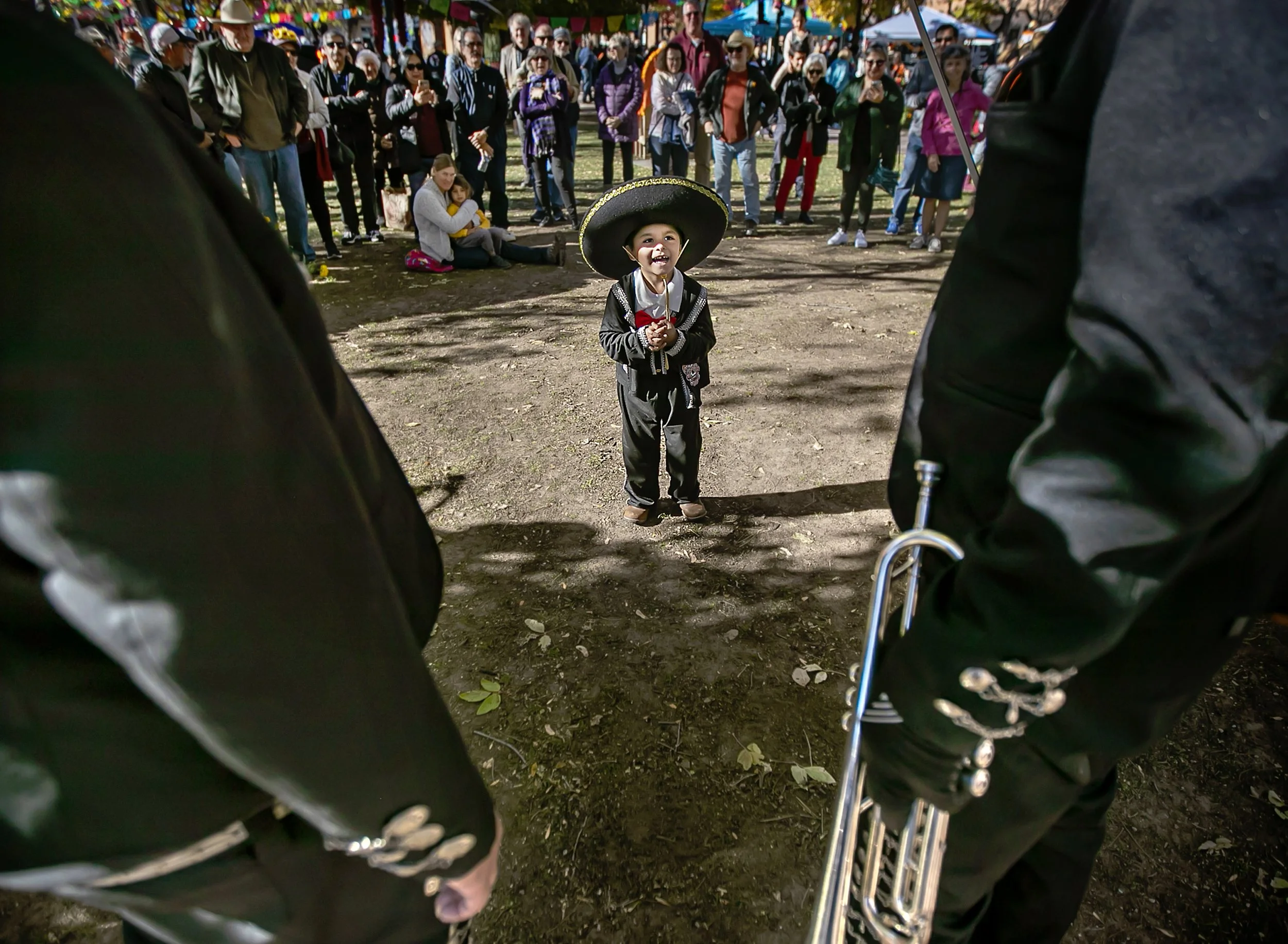  Three-year-old Isaac Mora steps forward to join the band as members of Mariachi Azteca De Santa Fe perform on the plaza during the inaugural Día de Muertos event in downtown Santa Fe on Oct. 29, 2022 featuring community ofrendas, live entertainment,