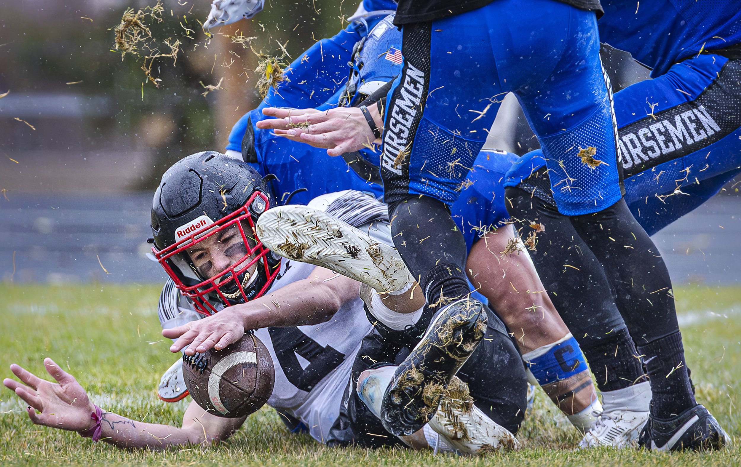  Colts quarterback Cole Seidenberger recovers a fumble after getting battered by the Horsemen defense during St. Michael's 41-0 blowout win over the New Mexico Military Academy in the Class 3A state semifinal game at St. Michael's on Nov. 18, 2023. 