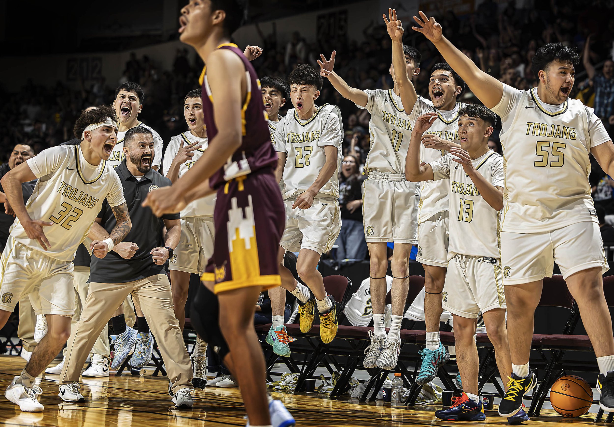  The Trojans celebrate after scoring a 3 point buzzer buster to go into overtime during Mesa Vista's Class 2A State Tournament semifinal against Rehoboth Christian at the Rio Rancho Events Center on Wednesday, March 11, 2026. 