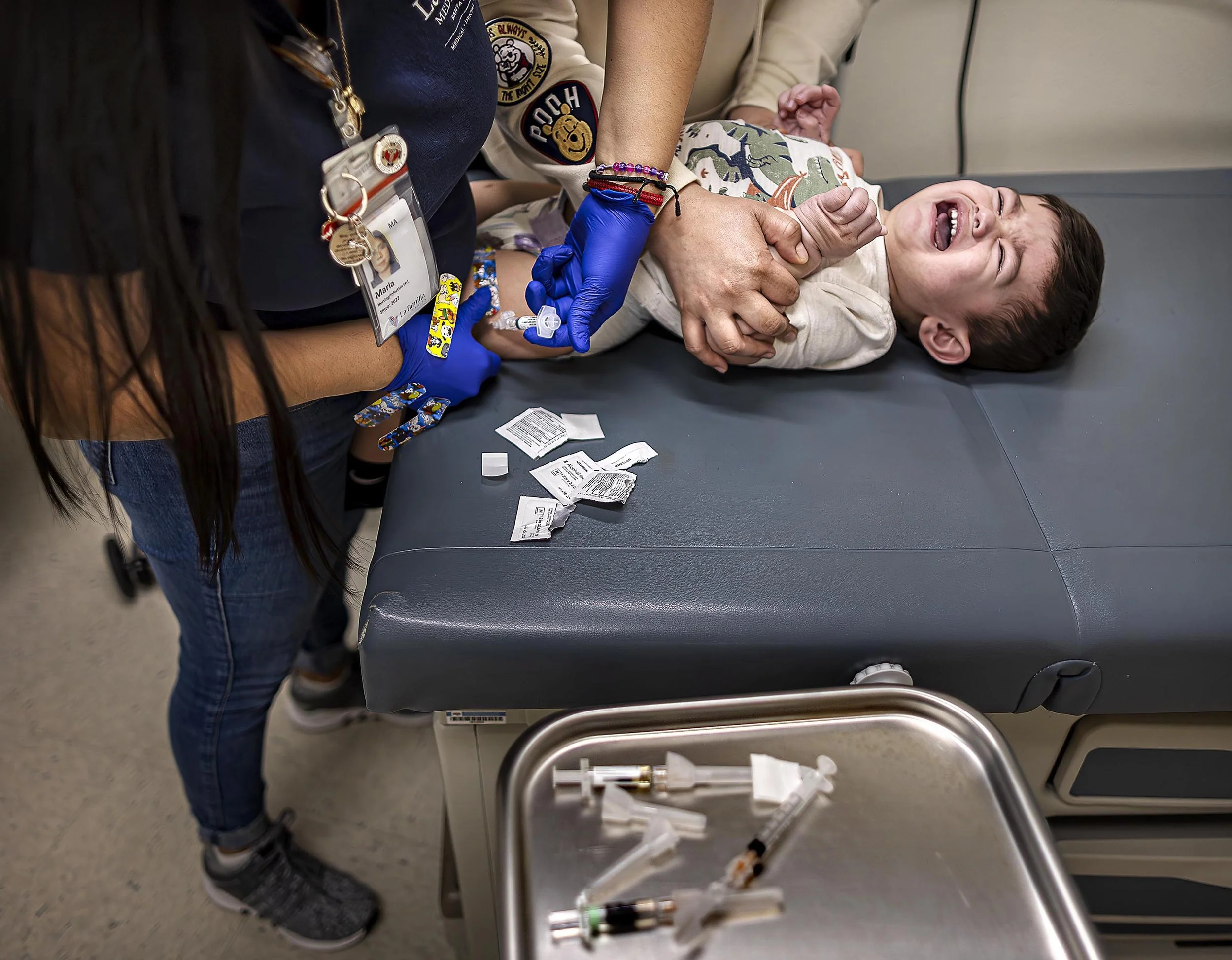  On Friday, Feb. 28, 2025 at the La Familia Medical Center, Medical assistant Maria Arriaga, left, gives Eighteen-month-old Liam Chavarria his MMR Vaccination, a newly relevant shot given the Measles outbreak declared in Lea County. State and local h