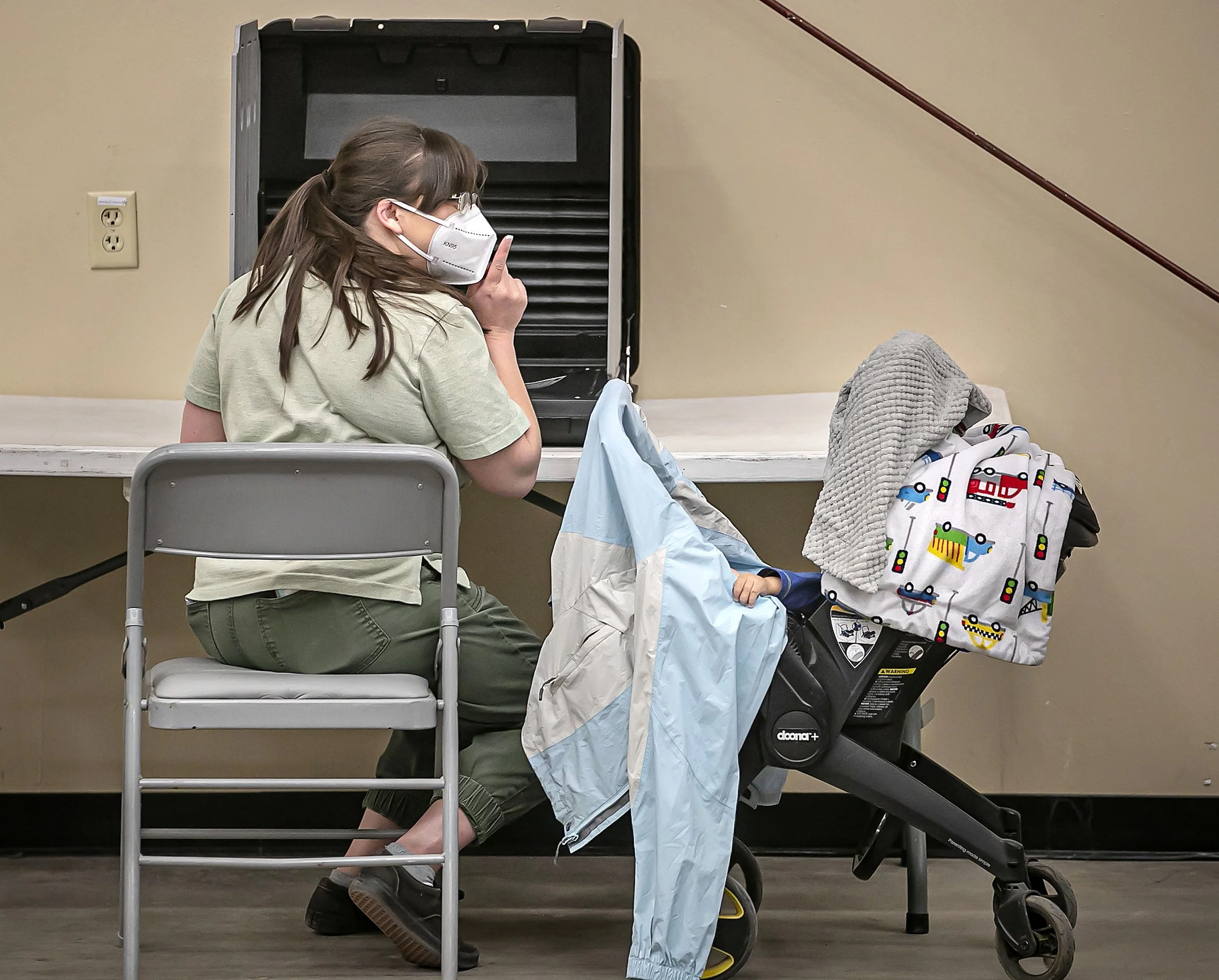  Cynthea Rodriguez tries to quiet her one-year-old nephew Ardal Rodriguez while she concentrates on her vote as Santa Fe residents lined up to cast their ballots at the Santa Fe County Fair polling location on Nov. 2, 2021. 