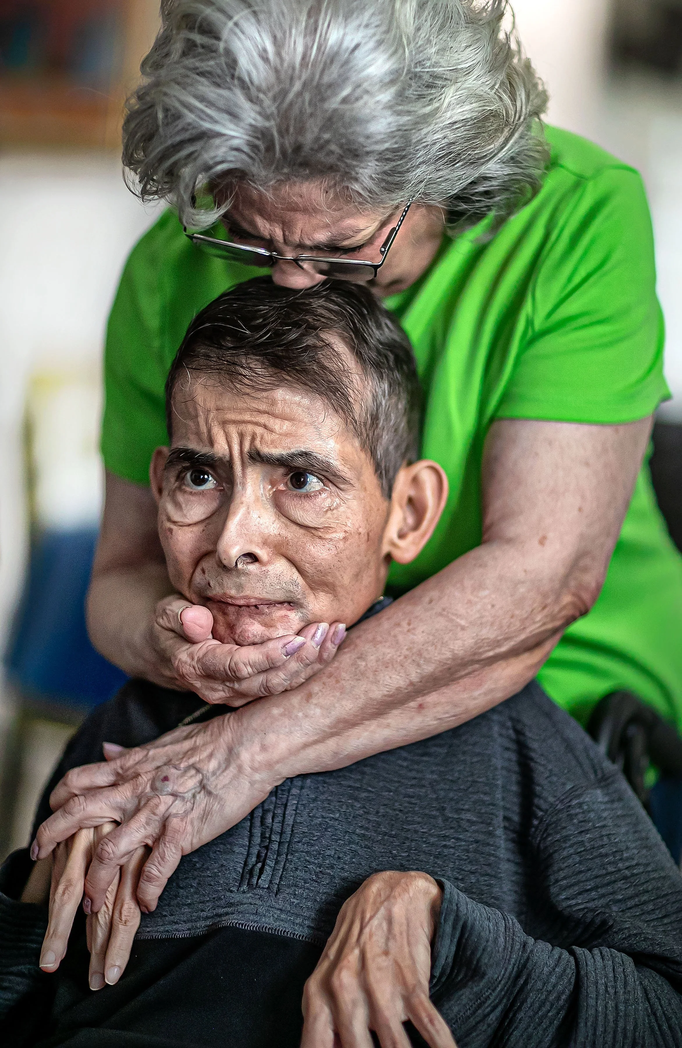 Angie Allen embraces her son Matthew Allen at their home in Santa Fe on Jan. 22, 2022. Matthew, at 6 months of age, was expected to be a vegetable, but that never happened. Although he's been unable to communicate verbally and has needed care all hi