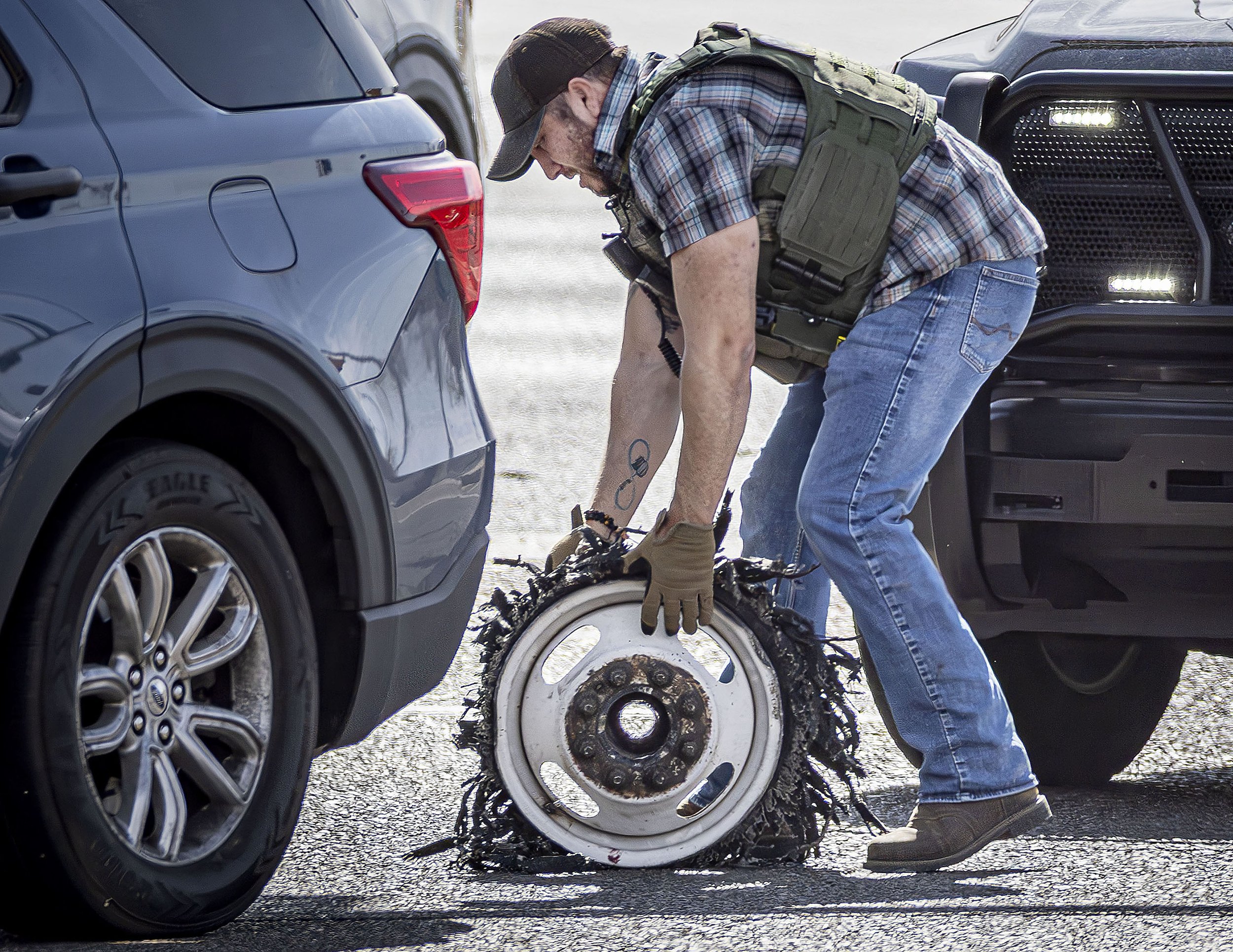  Investigators process the scene after a chase where officers pinned a U-Haul Truck trying to escape on Herrera Drive near the Walmart Supercenter, rescued a man and woman trapped in the back of the U-Haul and arrested the driver on Tuesday, April 8,