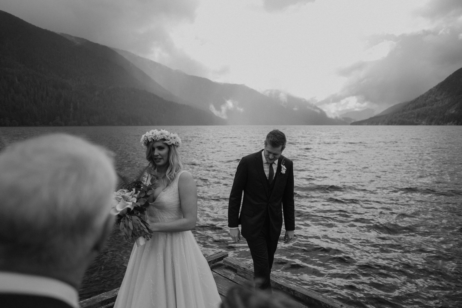 bride and groom at the shore of lake crescent lodge