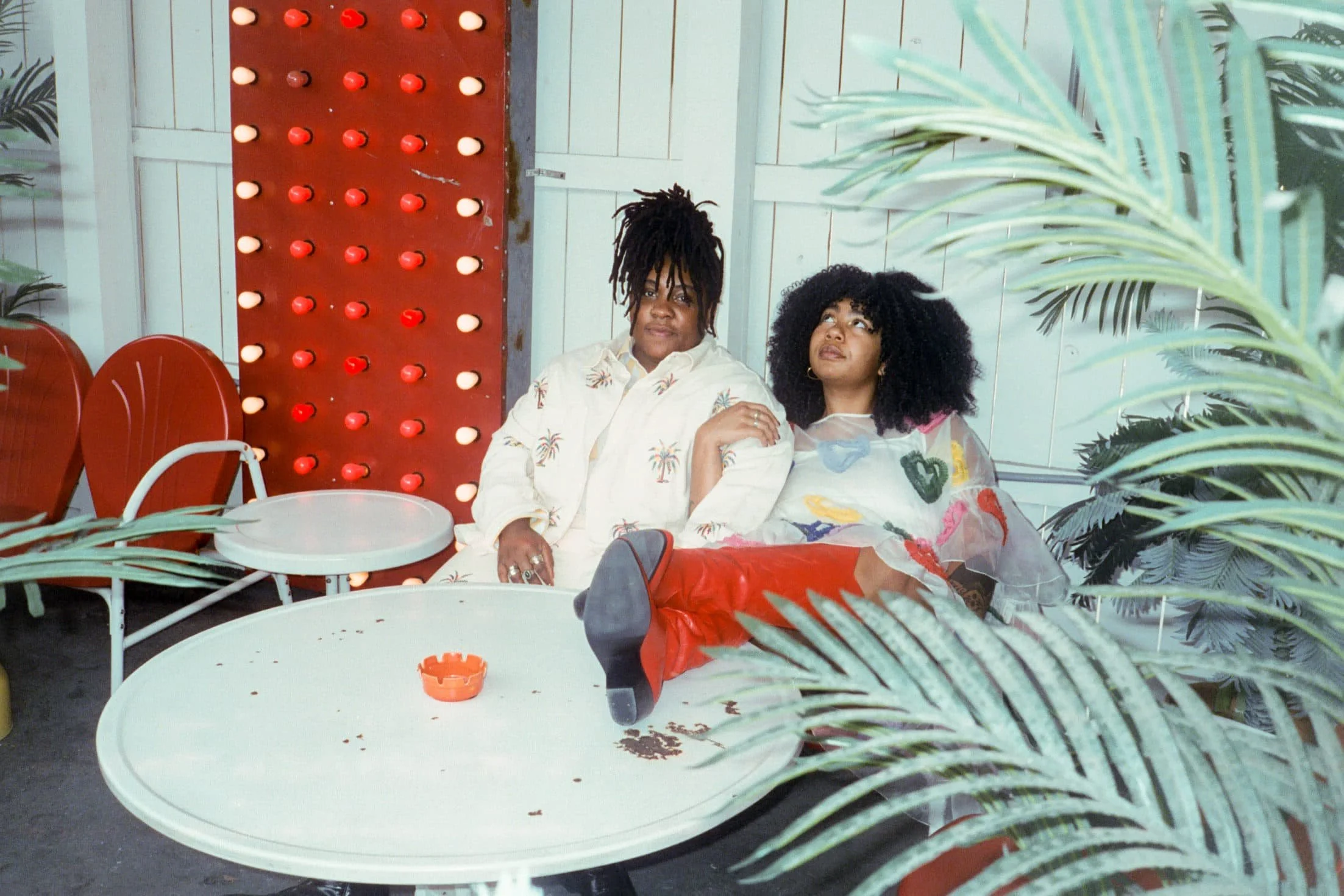 lesbian couple on their wedding day sitting outside of the dive motel in nashville