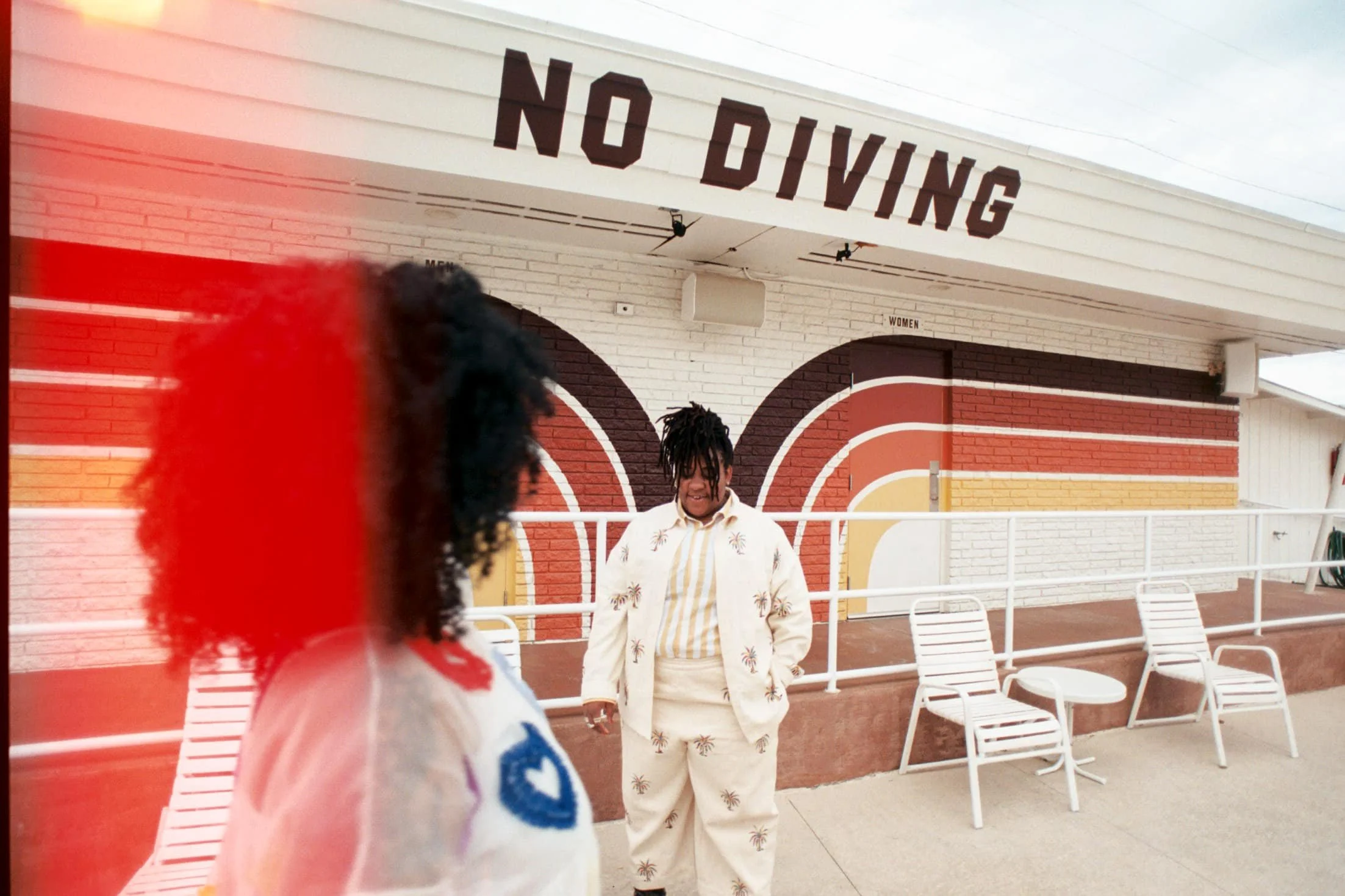 a light leak of a lesbian couple outside of a vintage motel in nashville on their wedding day at the dive motel 
