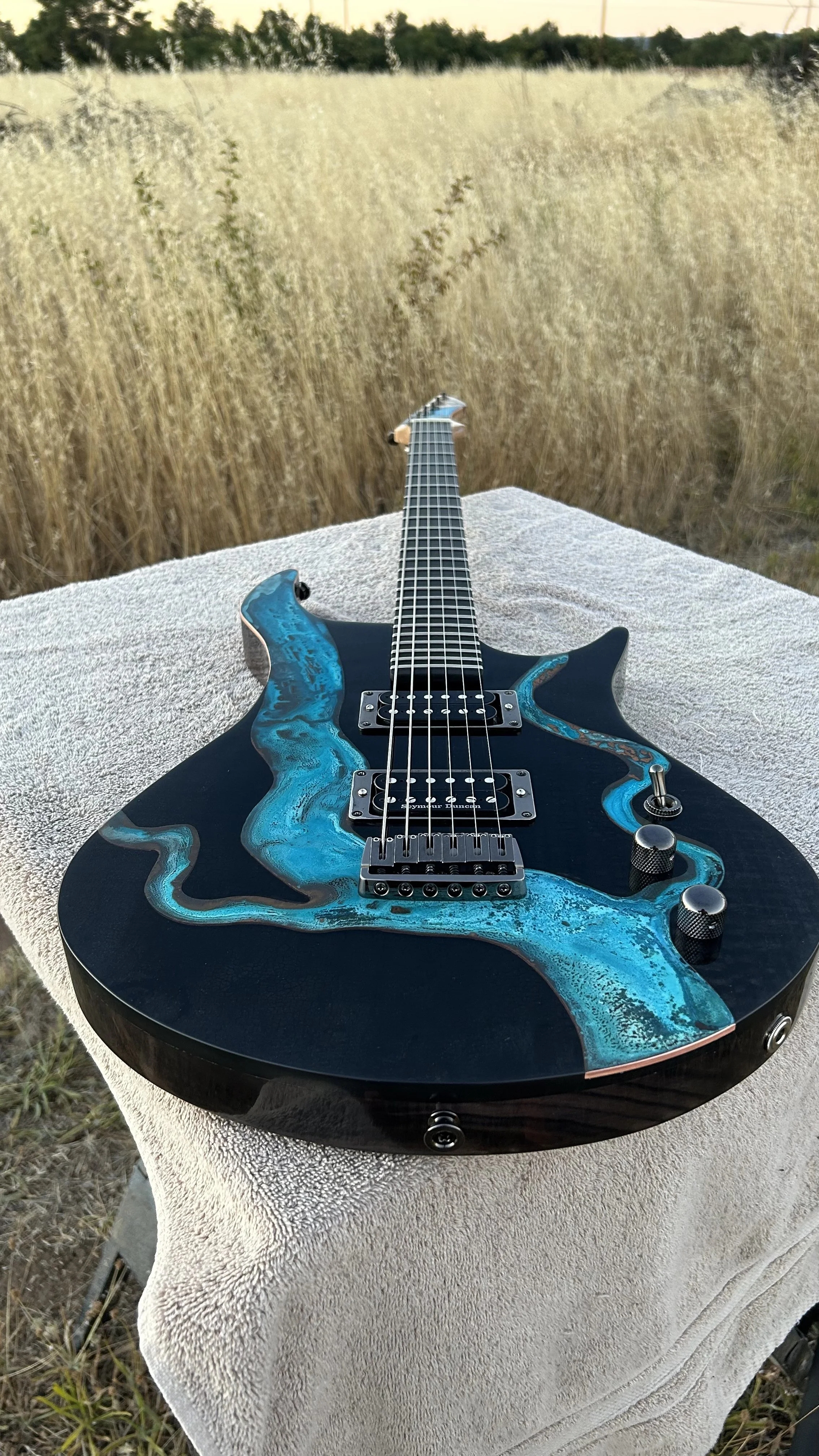 Wildfire Baritone- Made of charred Maple with a patina'd copper plate insert