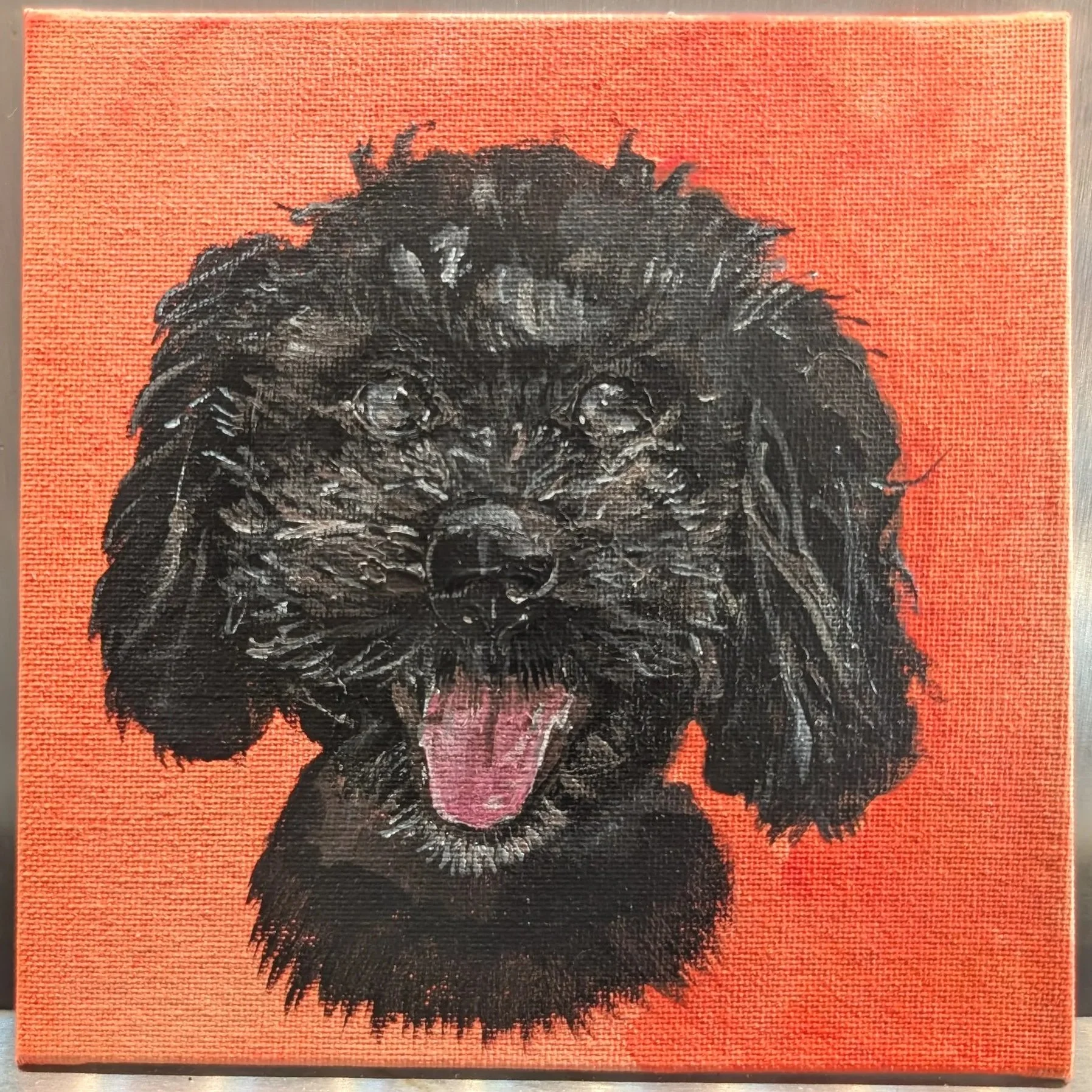 Painting of a black dog with a pink tongue against an orange background.